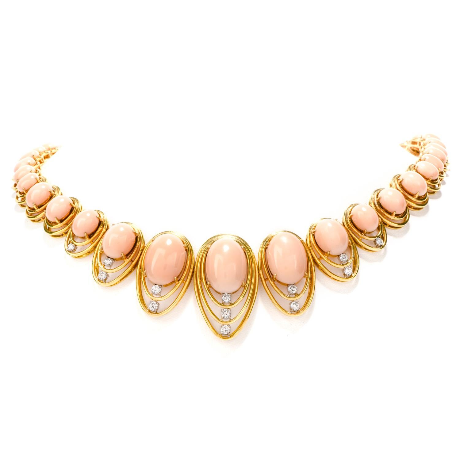 Exude classiness with this exceptional  Vintage 1970's Diamond Coral 14K Gold Oval Graduated Necklace! 
This necklace has 42 natural soft natural pink coral oval cabochons from 18mm to 8 mm long and 13 genuine, round cut diamonds, totaling 0.85