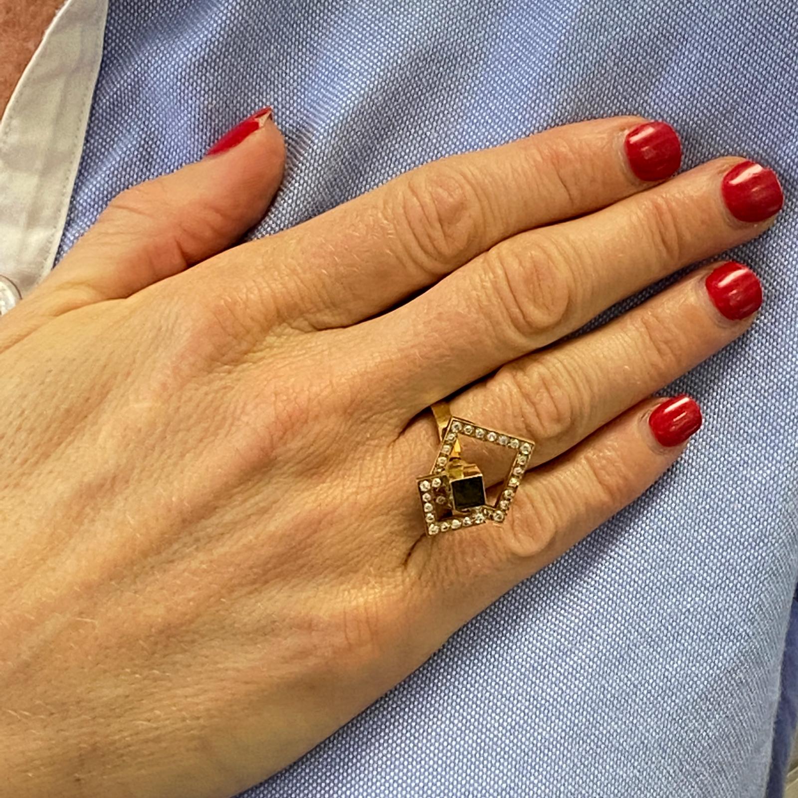 1970's diamond spinner ring fashioned in 14 karat yellow gold. The ring features 33 round brilliant cut diamonds weighing .50 carat total weight. The ring measures .60 inches in width, is currently size 6 (can be sized), and signed 1975 N. Tuefel. 

