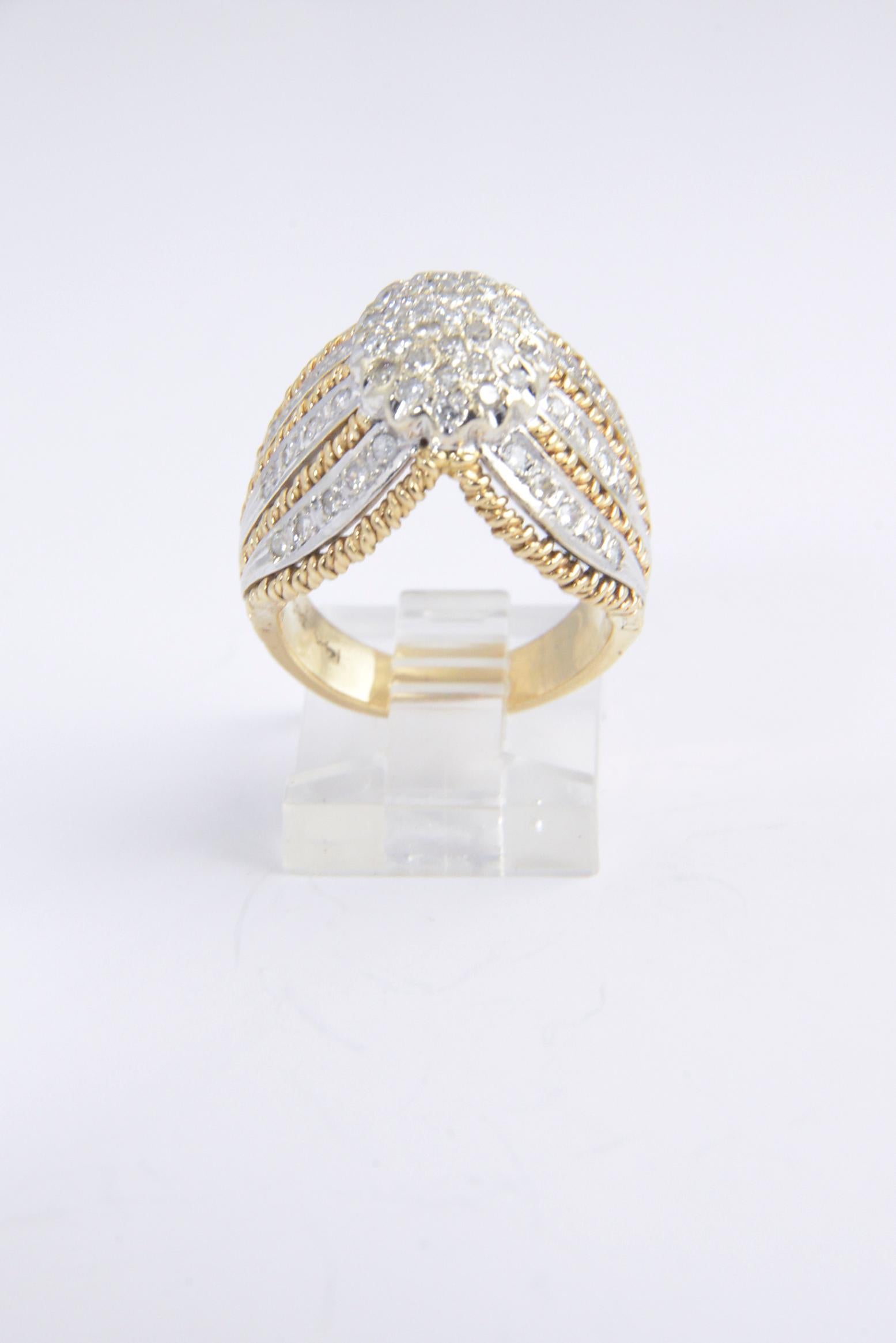 1970s 14K gold dome ring with diamonds set in white gold accented by yellow gold twisted edges.  There is approximately 1 carat of diamonds in the ring.
 Size: 6 1/4. Slight scratches on the band.