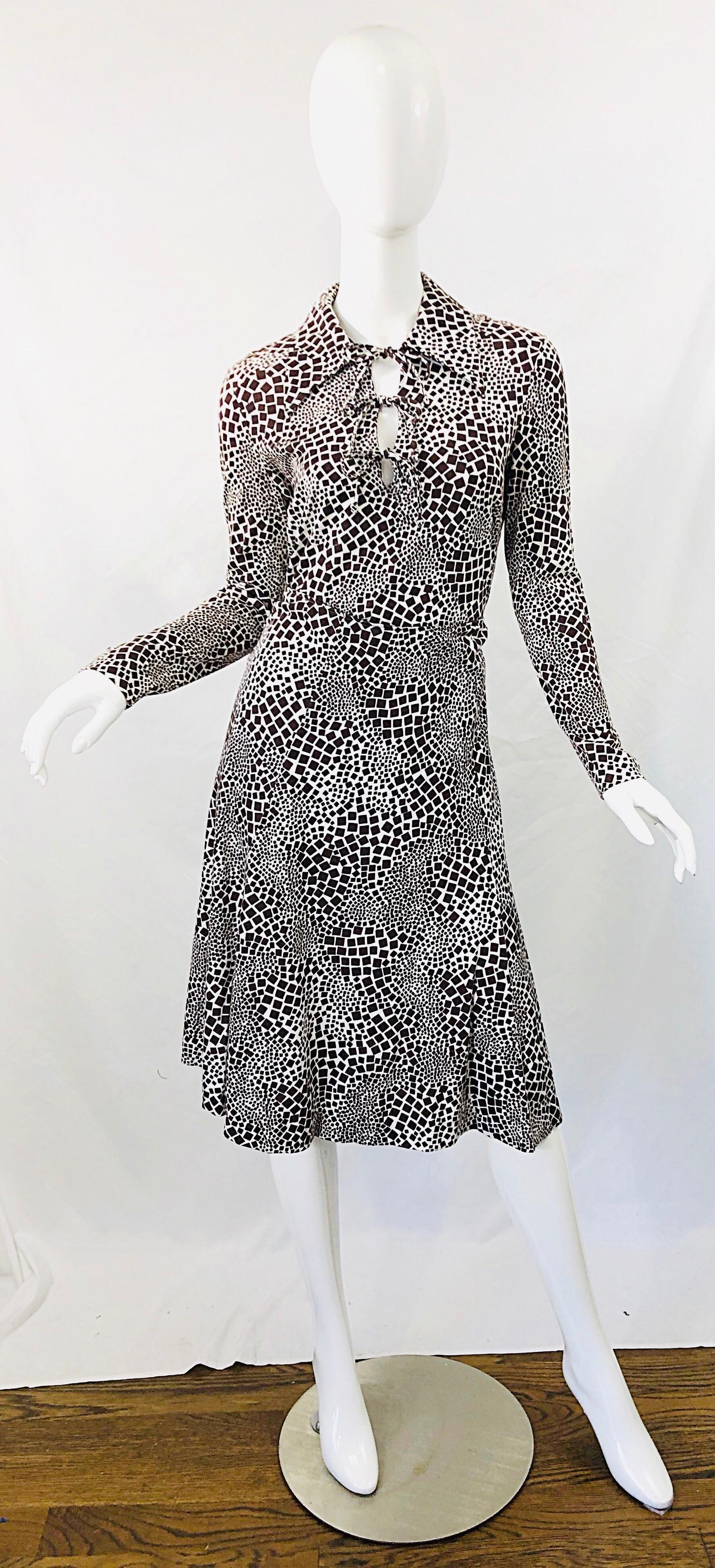 Chic 1970s DIANE VON FURSTENBERG chocolate brown and white abstract print cut-out shirt and skirt. Soft rayon and cotton blend fabric. Cut-out at center neck with three ties. Skirt features hidden metal zipper up the back with hook-and-eye closure.