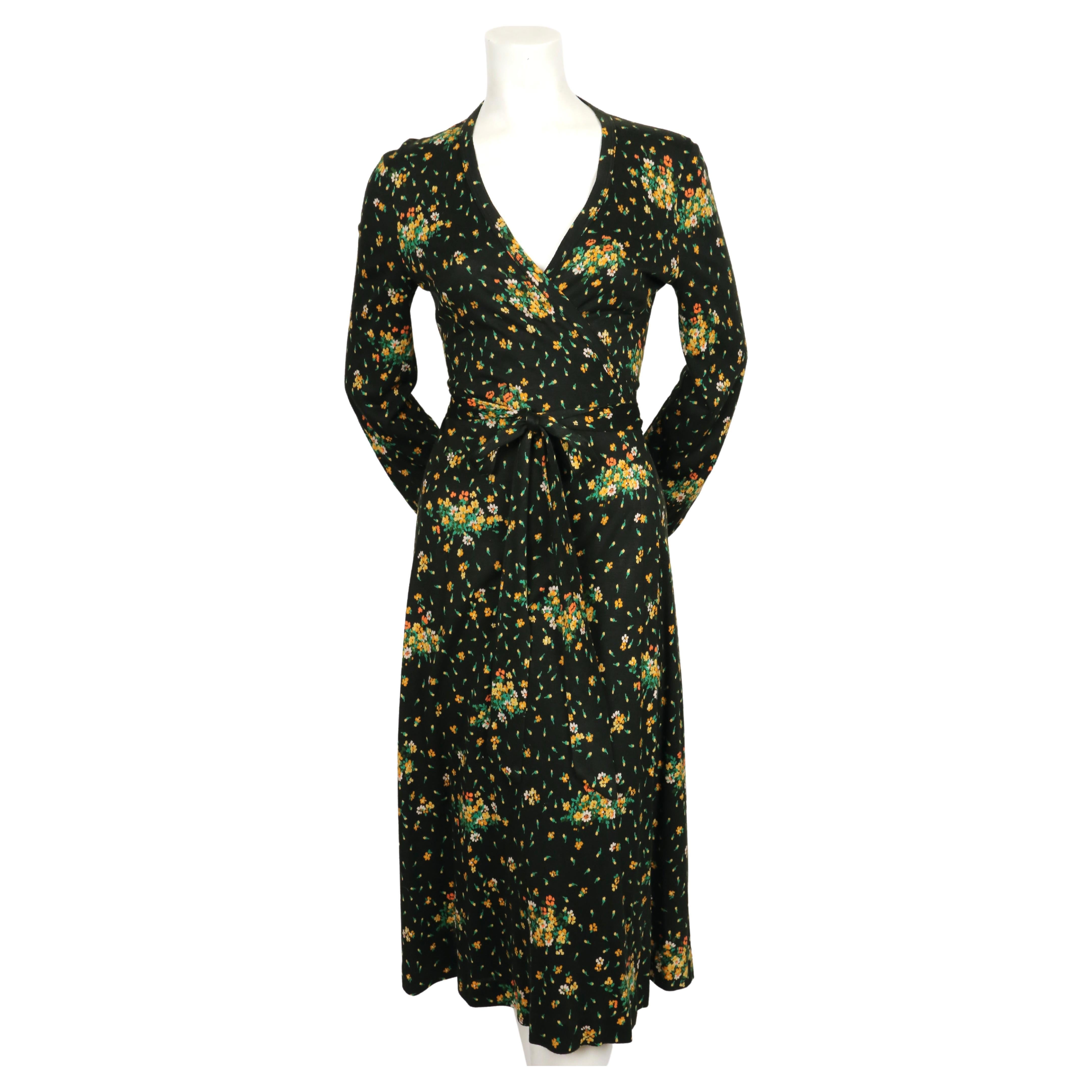Black floral-printed wrap dress by Diane Von Furstenberg dating to the 1970's. Vintage size 10 however this fits much smaller. The dress was not clipped on the size 2 mannequin. Best fits a US 4-6.  Approximate measurements: shoulder 14.5