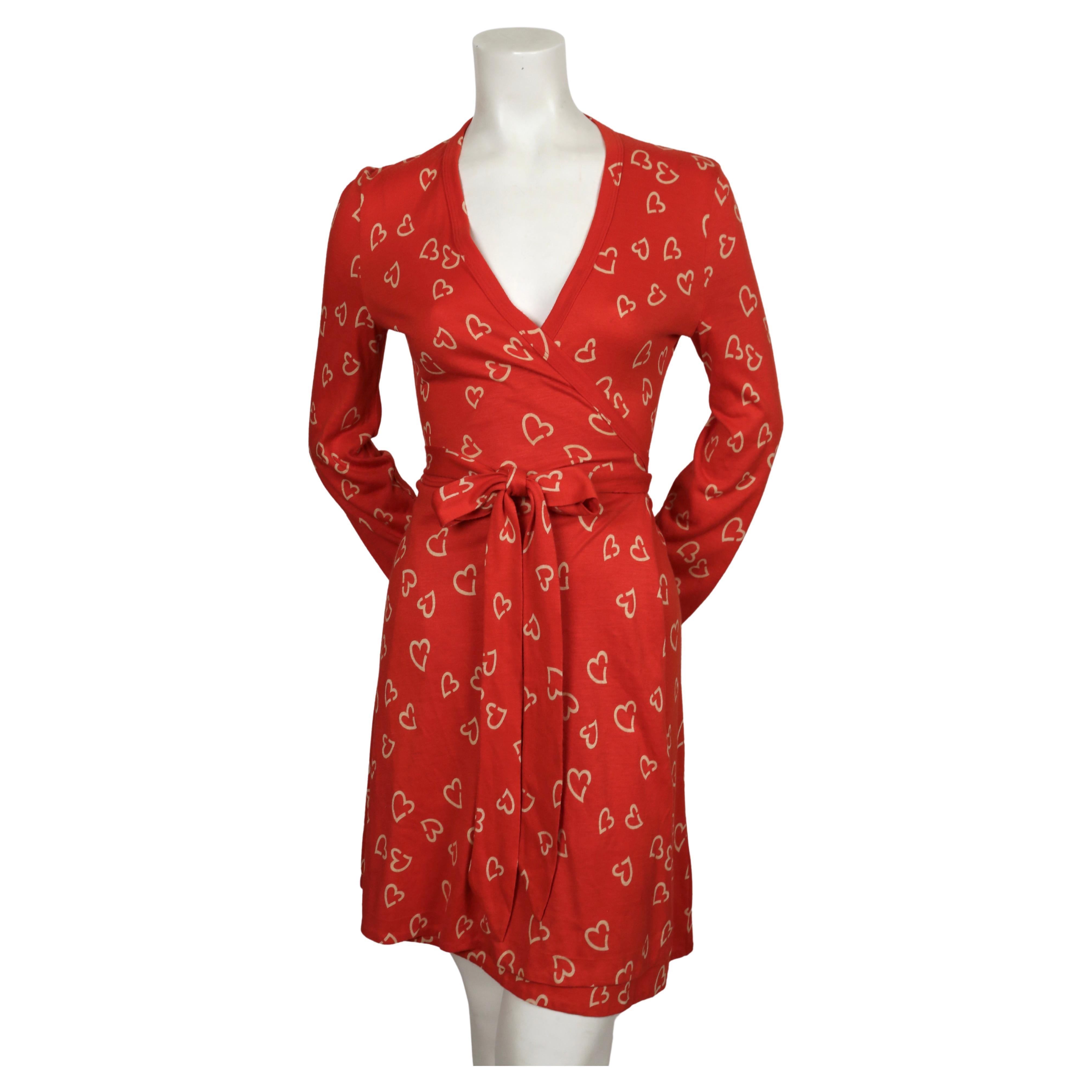 Red and off-white, heart-printed wrap dress by Diane Von Furstenberg dating to the 1970's. Vintage size 10 however this fits much smaller. The dress was not clipped on the size 2 mannequin. Best fits a US 4-6.  Approximate measurements: shoulder