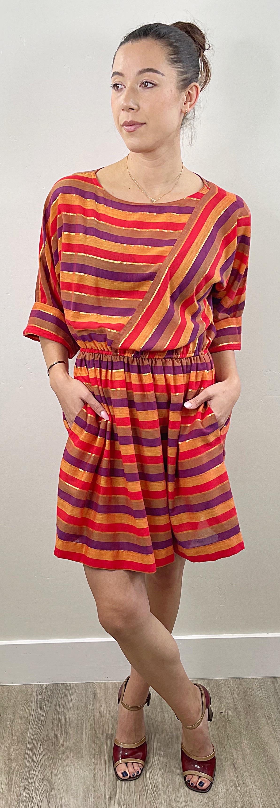 Late 1970s DIANE VON FURSTENBERG 3/4 sleeves autumnal dress ! Features wam tones of red, orange, purple, and gold metallic. Elastic waistband and dolman sleeves can accommodate an array of sizes. POCKETS at each side of the hips. Soft cotton blend