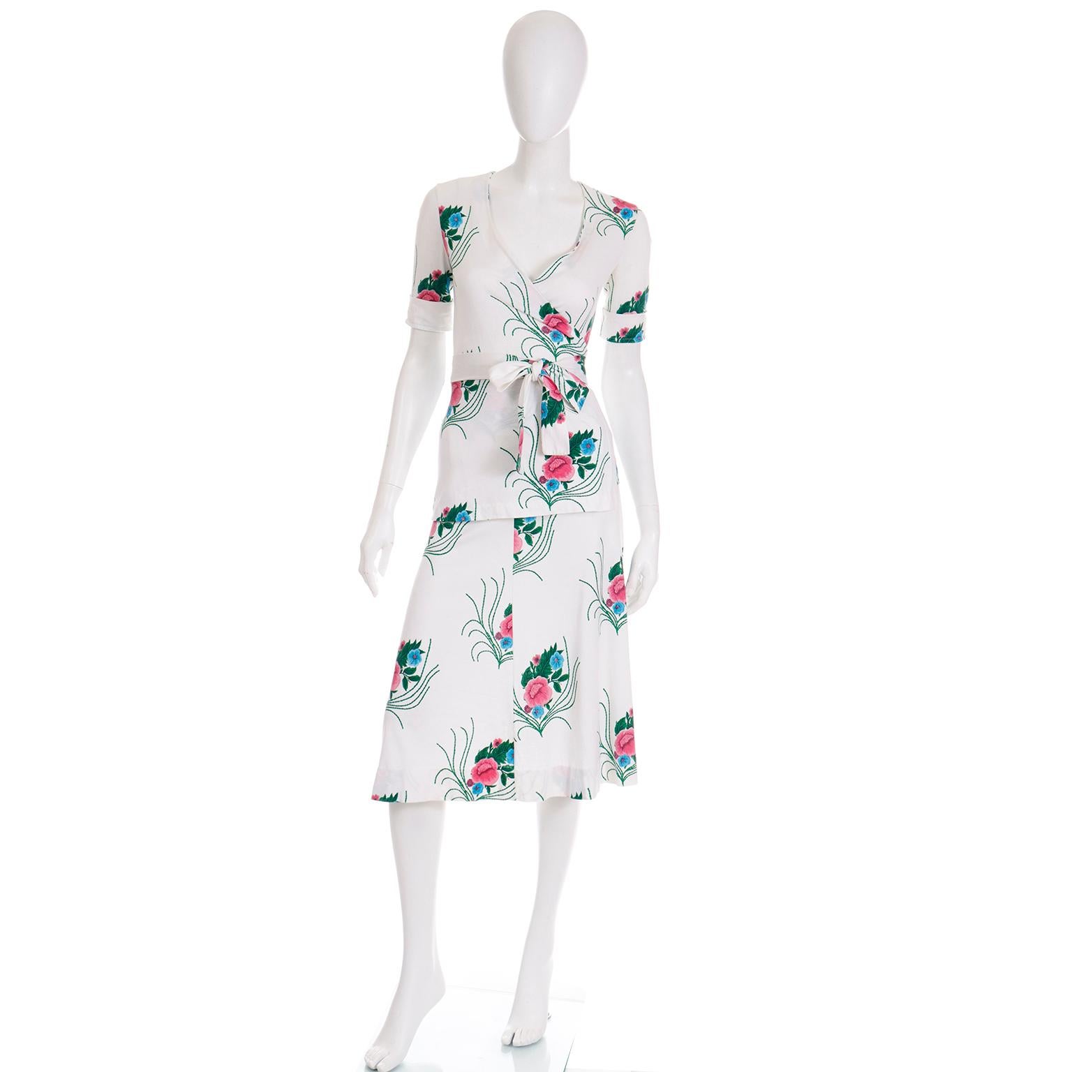 This is a really fun 2 piece outfit designed by Diane Von Furstenberg in the 1970's for Miss Magnin at I Magnin. The 2 pc dress is in a pink blue and green floral print on a white background. Made in Italy of 50% Cotton and 50% rayon. The top is