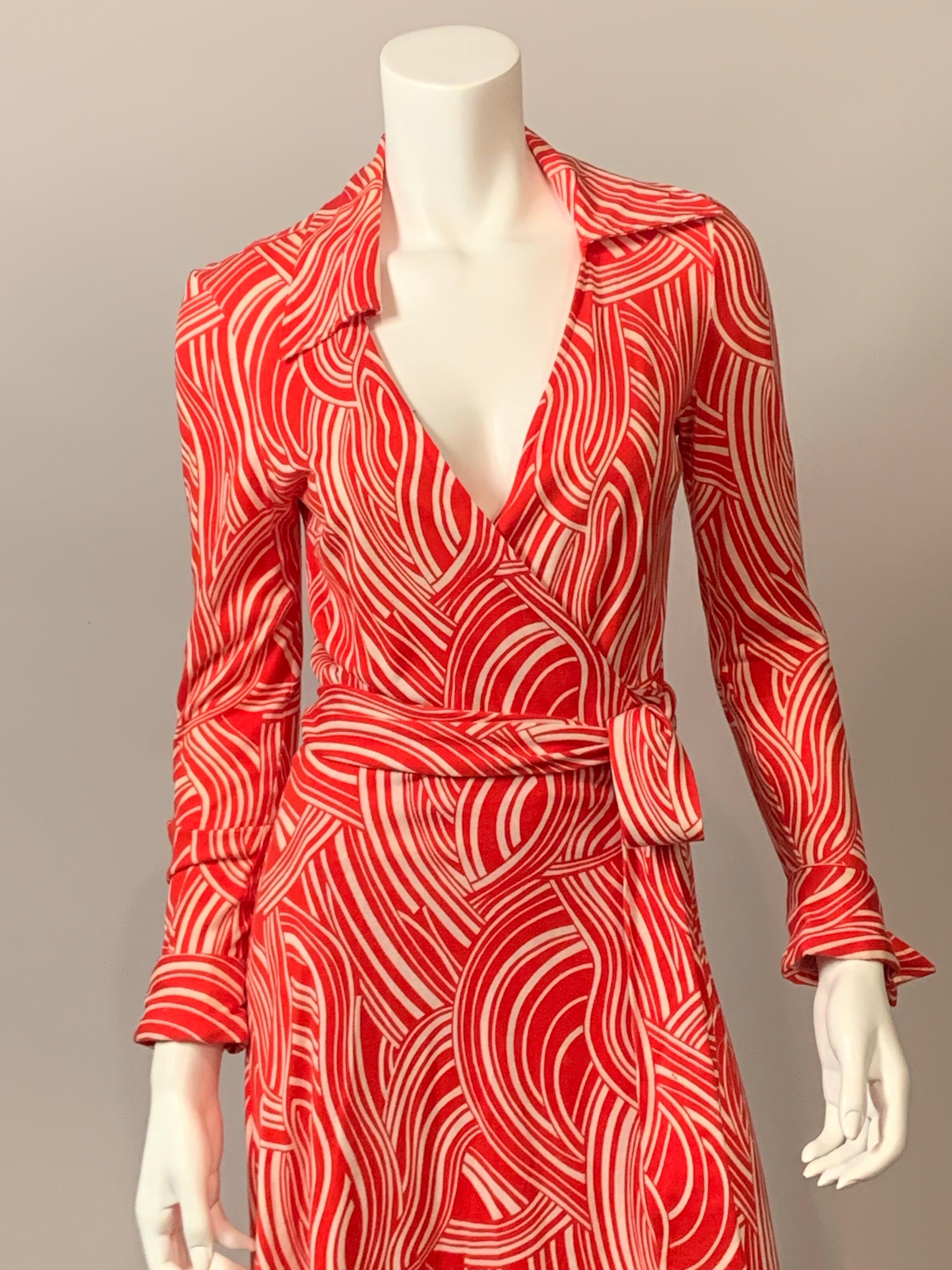 Diane von Furstenberg designed her iconic wrap dress in 1974 and it became a symbol of women's liberation.
This version of the dress is made with a cheerful red and white swirl pattern cotton knit. It has a pointed collar, wrap closure on the left