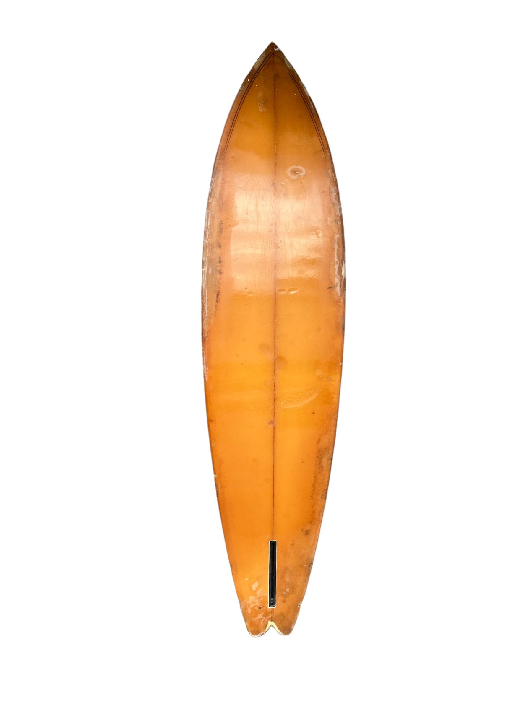 Mid-late 1970s Dick Brewer Surfboards single fin shaped for Burton “Buzzy” Kerbox by Joe Blair. Features a unique arrowhead resin pattern with swallowtail shape and double pinstriped border lines. Burton “Buzzy” Kerbox was a renowned surfer in
