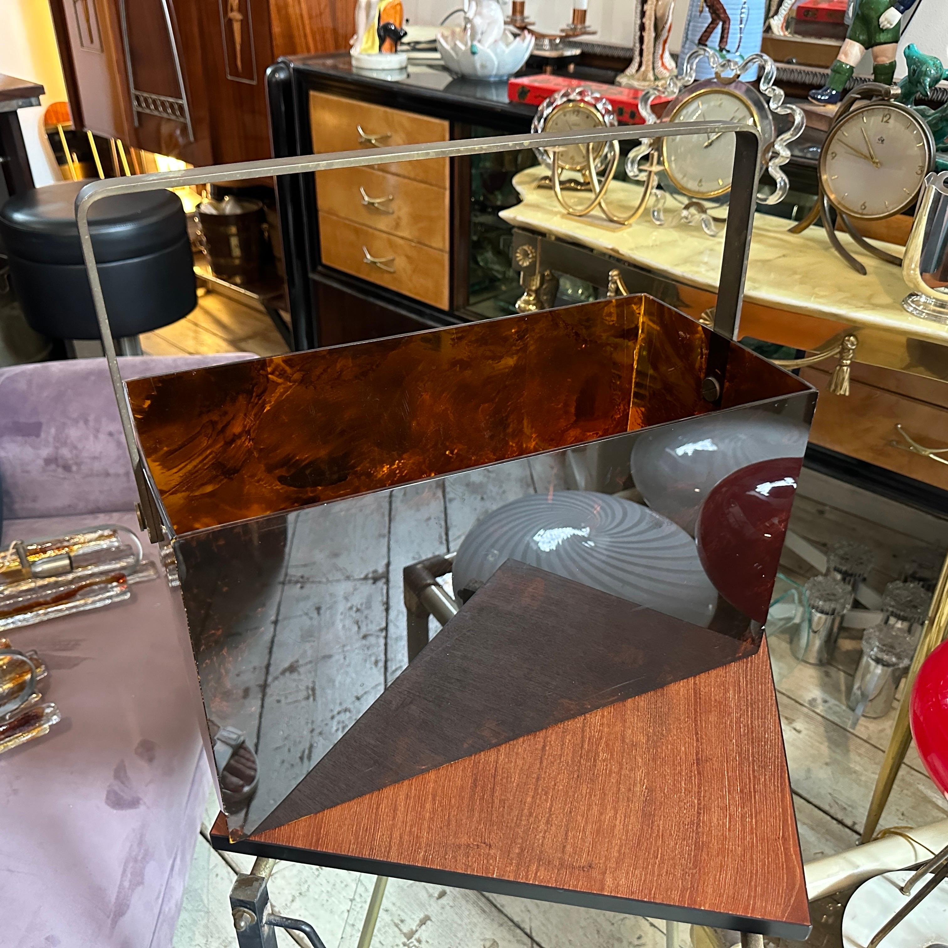 This piece reflects 1970s mid-century modern design principles, with a touch of Hollywood Regency style, which emphasized opulence and bold, glamorous materials like Lucite and brass. The tortoise shell motif is also an iconic element of high-end
