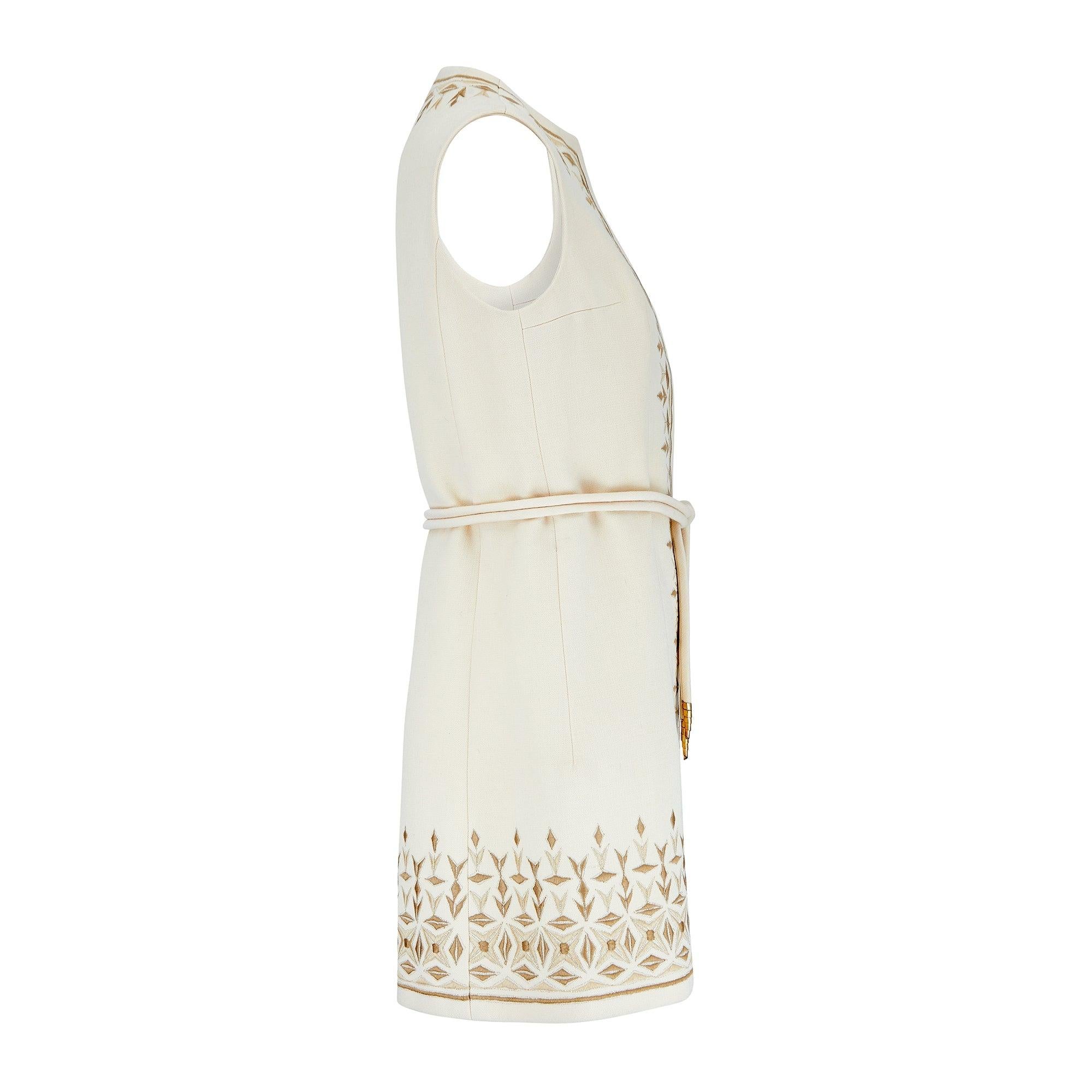 This late 1960s to early 1970s tunic has the original label which reads “Diorling by Christian Dior - London” in elaborate embroidered calligraphy and it is numbered. Crafted from stiff, rich cream wool, this playful piece is patterned with