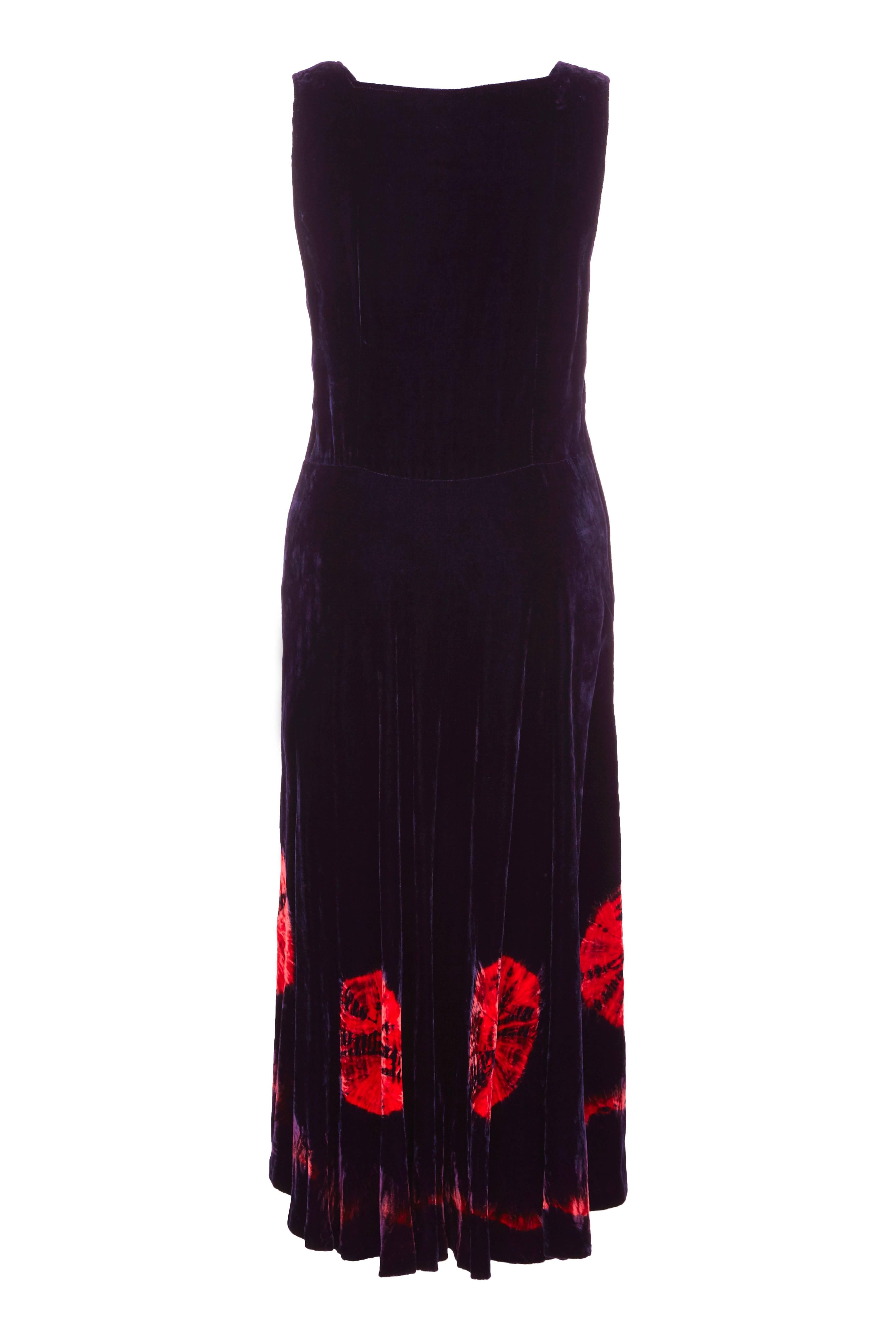 Beautiful vintage late 1960s or early 1970s dress in deep purple with bold orange/red tie-dye pattern on the front of the bodice and around the hem.  This dress has a very 1940s feel to it with a full calf length skirt and could be easily dressed up