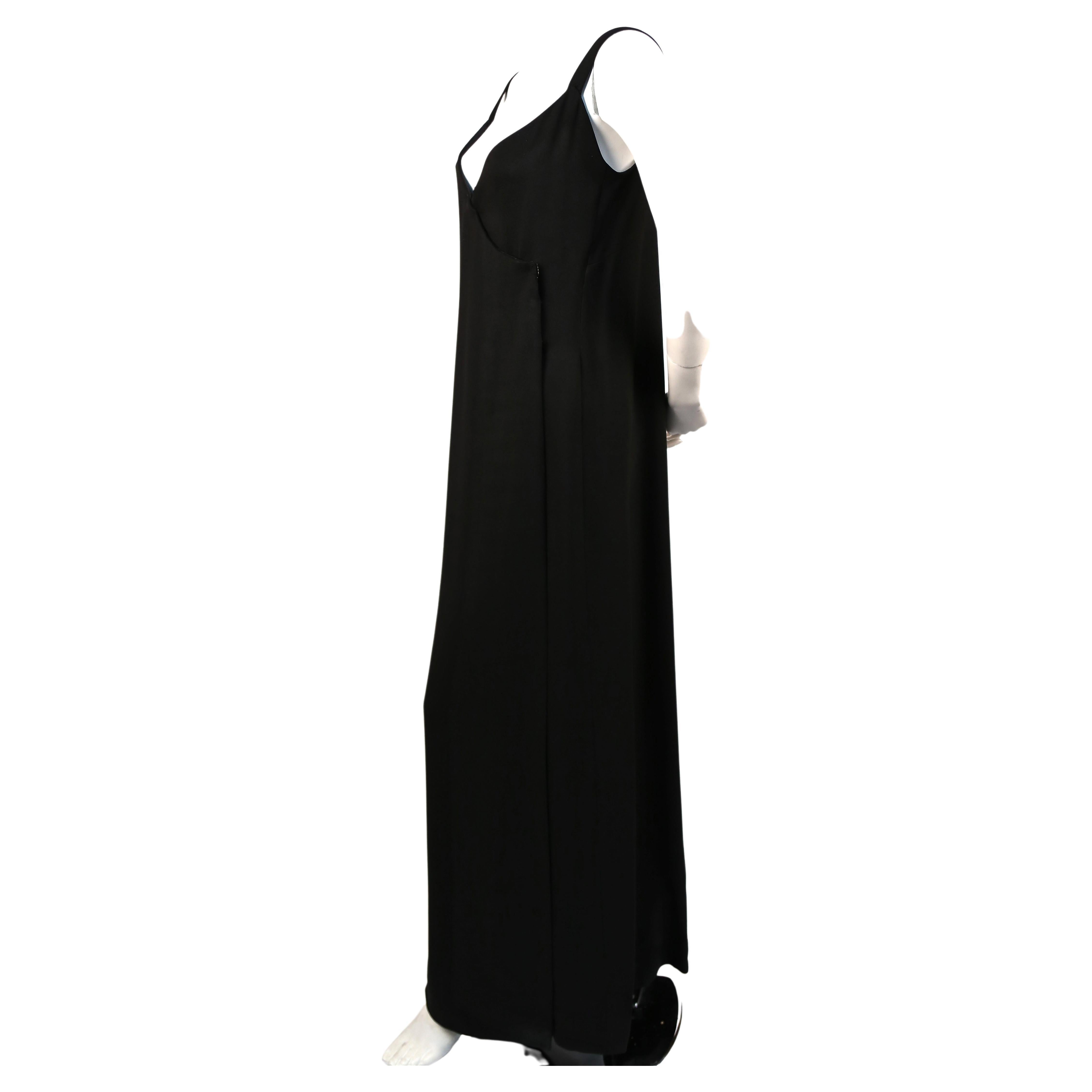 Long sleek textured wool wrap dress with snap closure from Donald Brooks dating to the 1970's. Very simple architectural fit. No size indicated however this best fits a size 4. Approximate measurements: bust 32-34