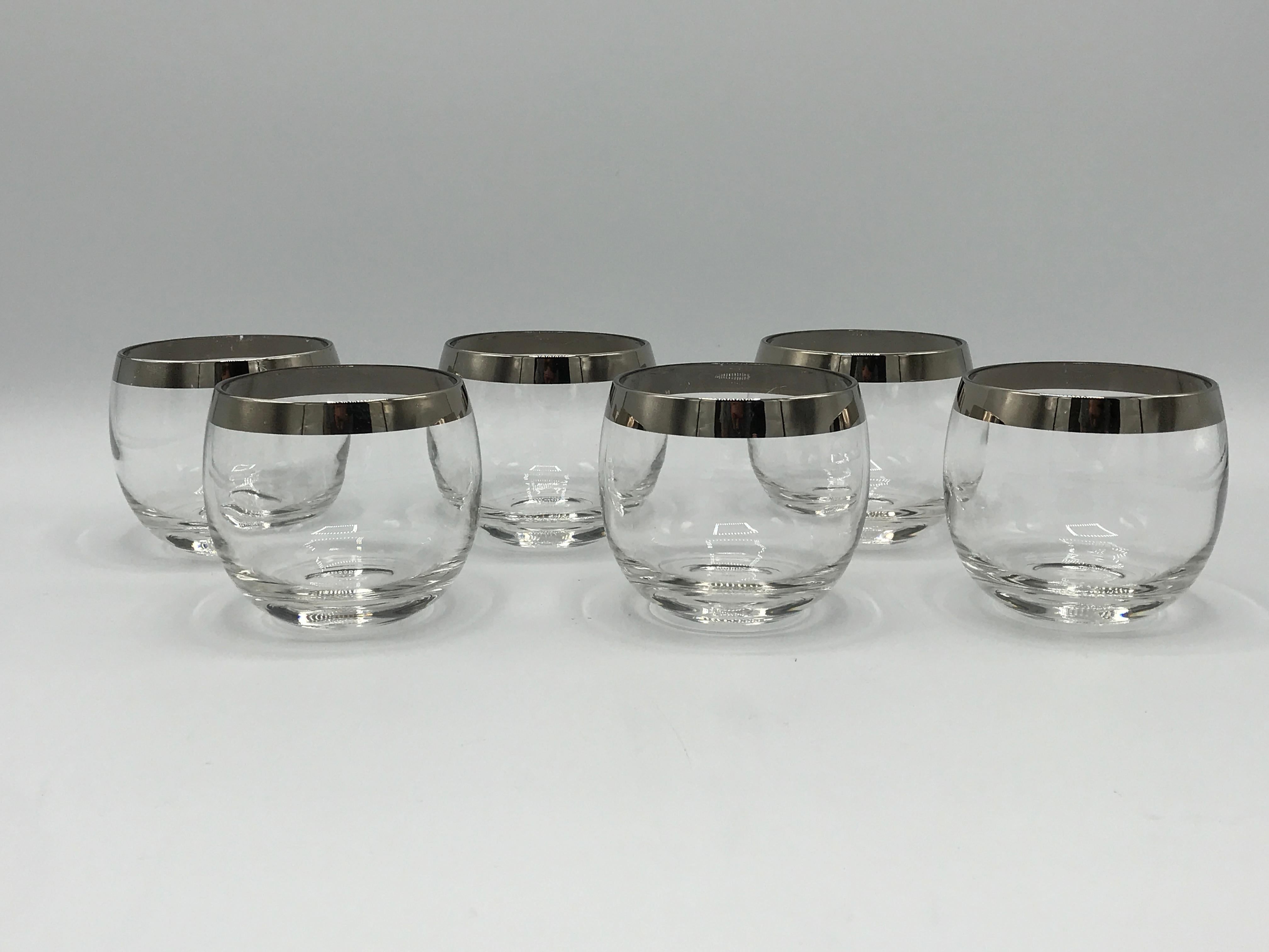Offered is a beautiful, set of six, 1970s Dorothy Thorpe stemless cocktail glasses. The set has a minimal, yet striking silver rim along the lip of each glass.