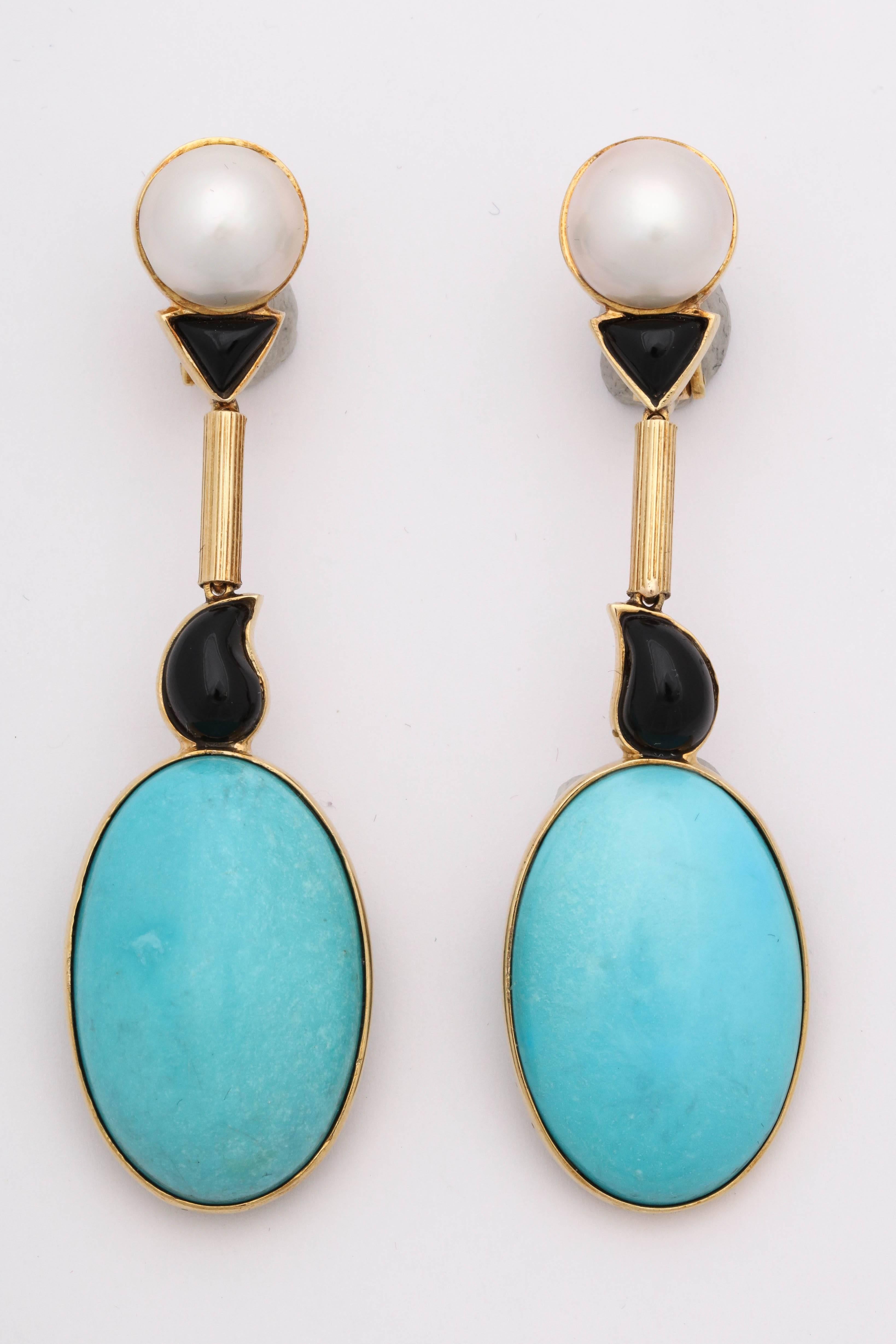 One Pair Of Ladies Long Pendant Drop 18kt Gold Earrings Designed With Two Large Bezel Set Sleeping Beauty Turquoises Measuring Approximately 32MM Each Stone,These Pendant Drop Clip On Earrings Are Also Designed With Two Palsey Custom Cut Onyxes