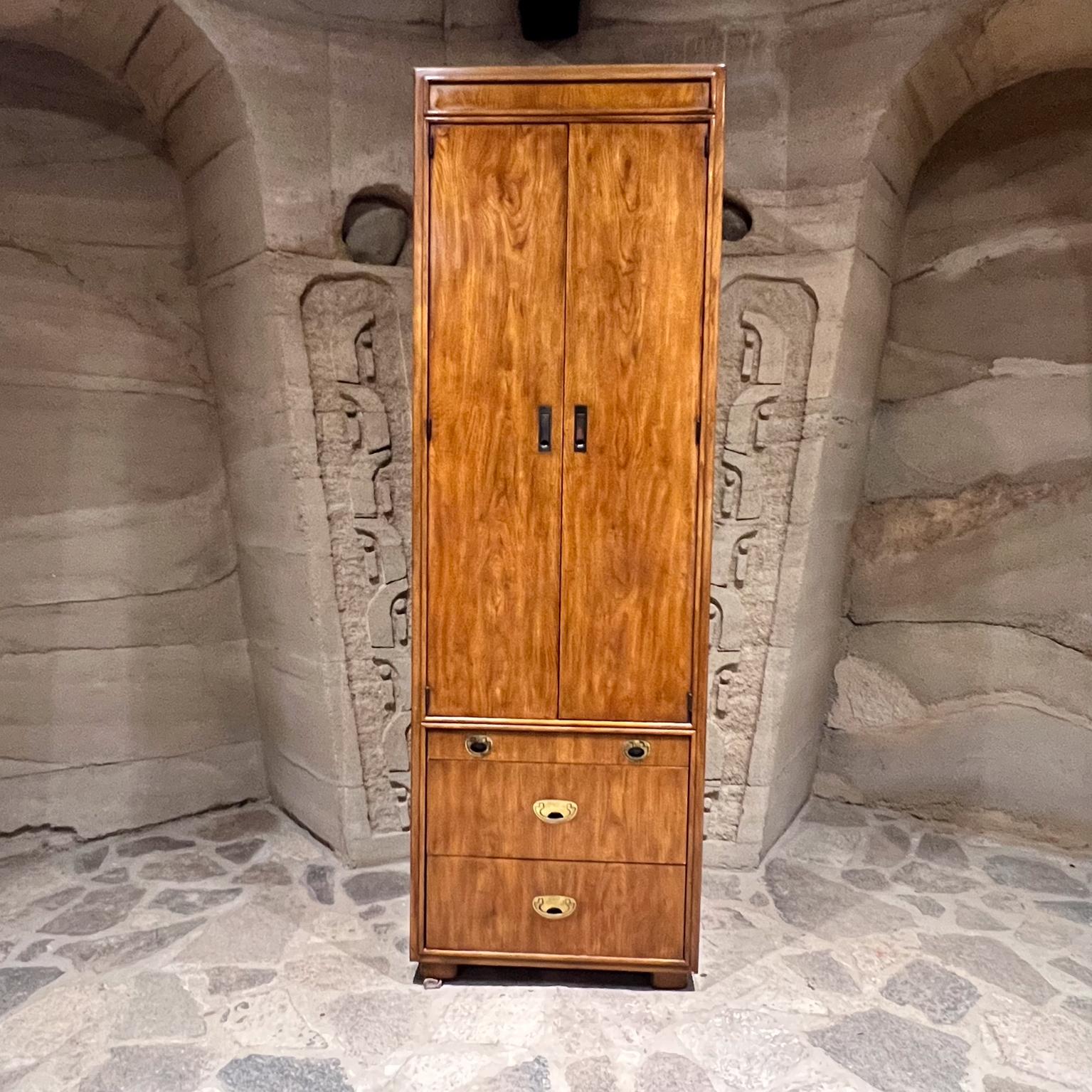 1970s Tall Drexel Passage Campaign Cabinet
2 roomy drawers at bottom + valet service pull out table.
Top door has open storage plus 2 interior drawers.
Stamped Drexel. Passage line. High chest.
Not new. Vintage unrestored condition. Inside storage