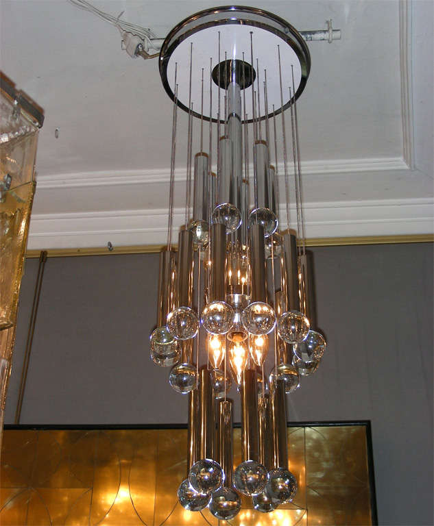 1970s Dutch chandelier by RAAK Lighting, in chrome and white metal, with chains holding glass spheres. Four lights.