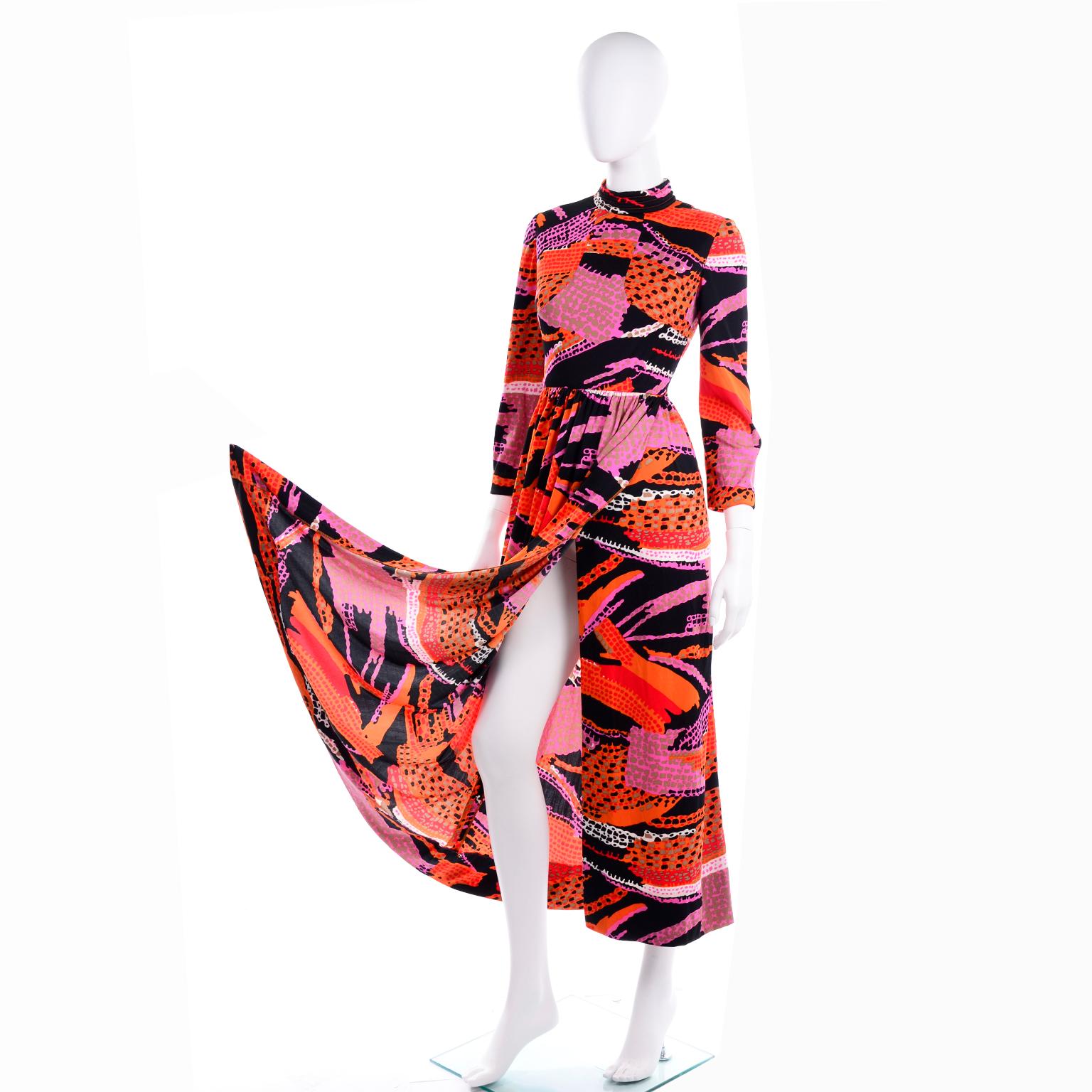 This great vintage early 1970's Dynasty knit dress is in an incredible orange, purple, black and pink, abstract print. The bust is lined and the dress closes with a hook and eye on the back of the neckline as well as a metal zipper down the center