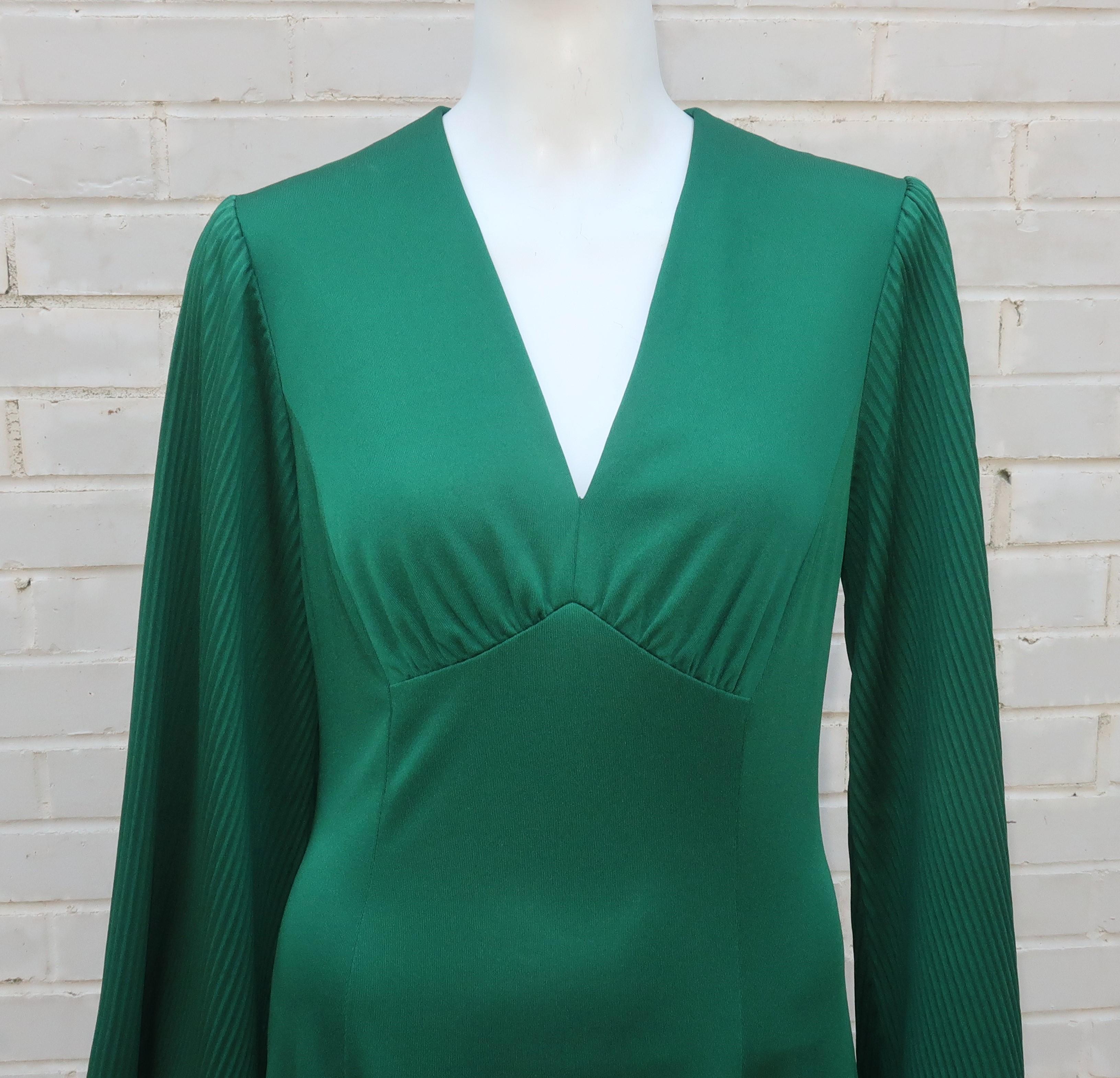 Disco diva in emerald green!  This 1970's Edith Flagg design is a period perfect look and a great cut for the dance floor.  The emerald green polyester jersey is easy to wear and the construction includes ruched detail at the bust and micro pleated