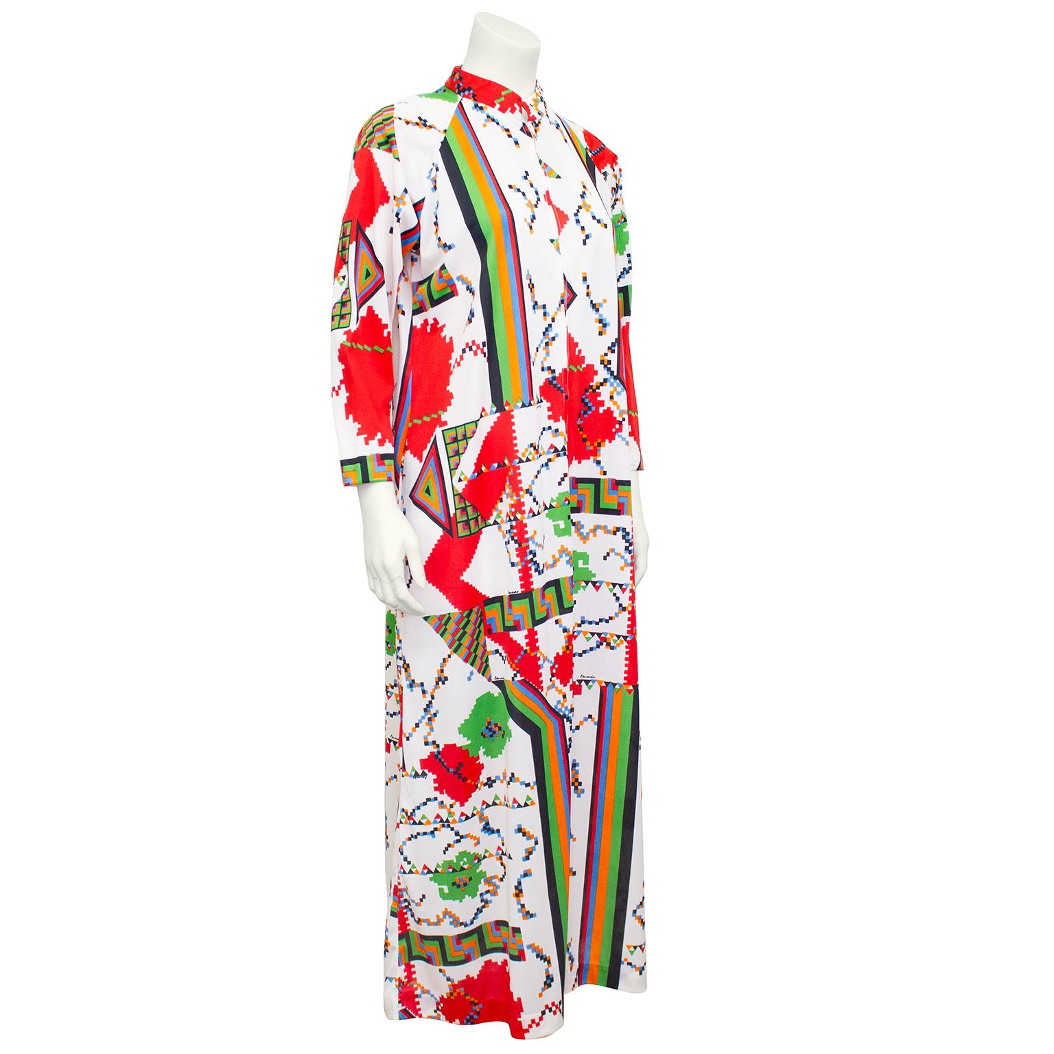 1970s polyester printed maxi hostess robe by the Italian designer Eduardo for Saks Fifth Ave. Mandarin neckline with zipper at centre front. Long sleeve and wide through body, giving it a kaftan shape. All over white, green, blue, orange and black