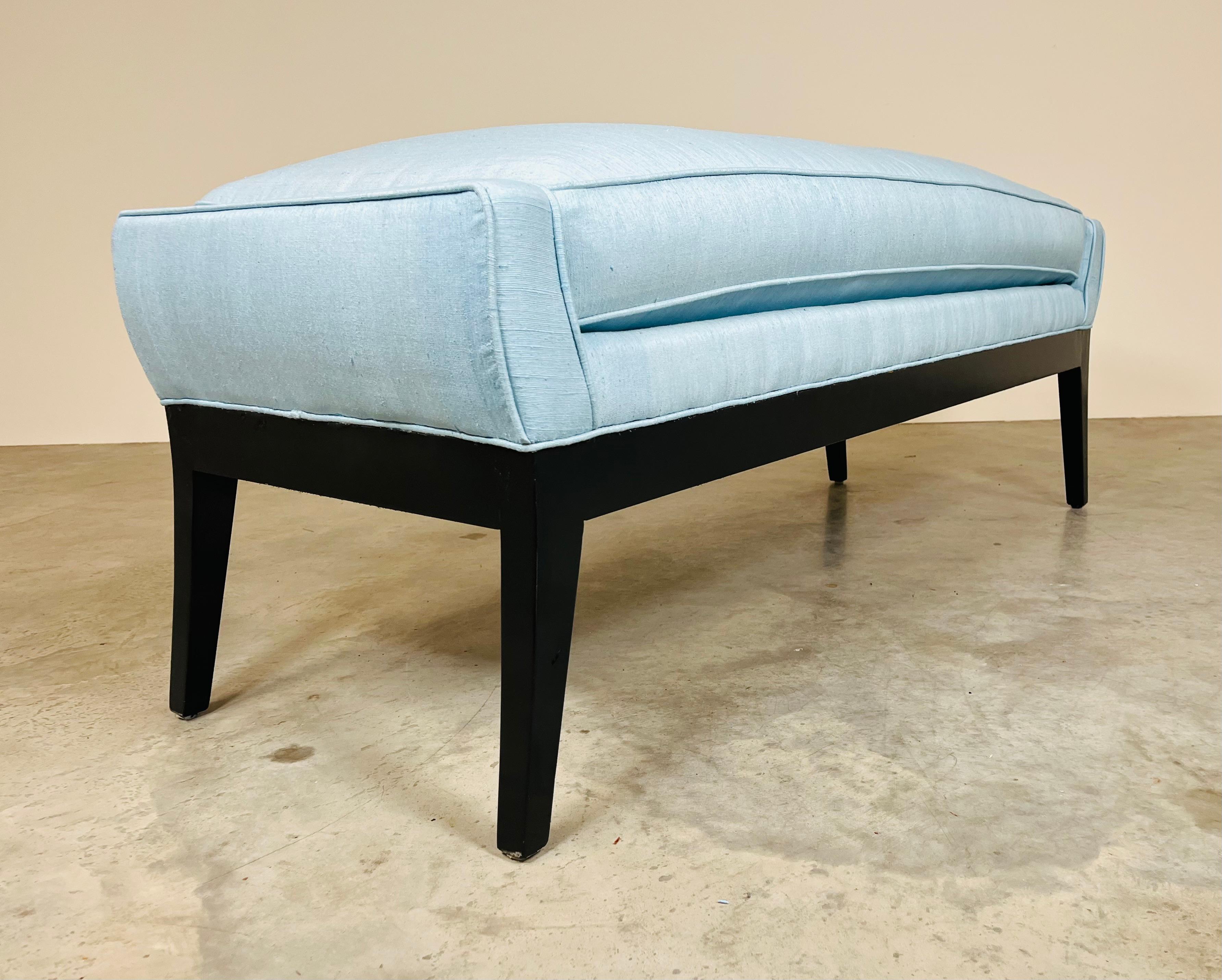 Fully restored Mid-Century Modern window bench attributed to Edward Wormley for Dunbar. Splay leg design constructed of newly black lacquered hardwood frame.
Stationary plush single cushion is upholstered in light blue silk accented with matching