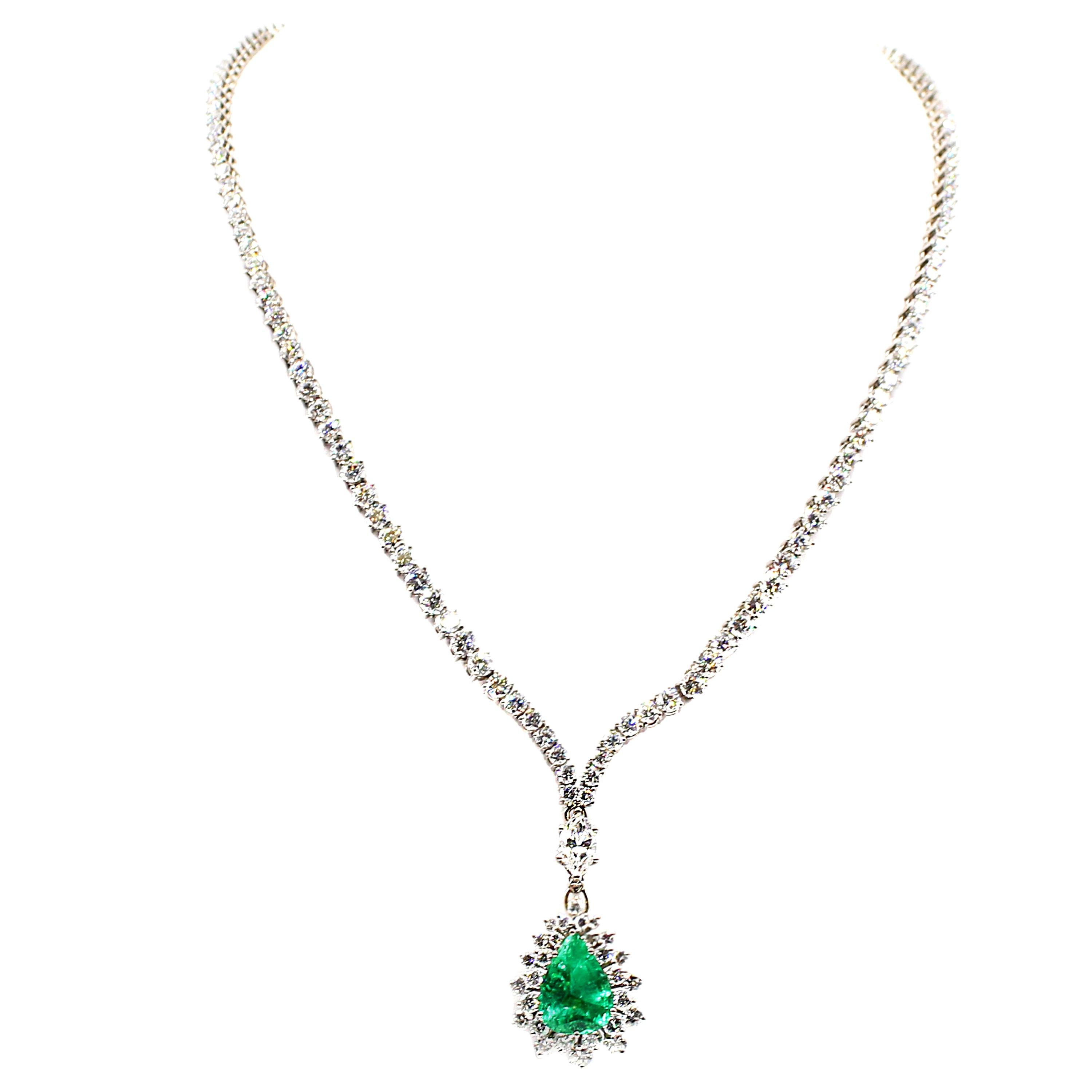 This elegant necklace is a classic, featuring a bright green pear shaped Colombian emerald weighing approximately 4.5 carats. Masterfully hand-crafted in 18 karat white gold this riviera necklace which ends in a V-shape is set with 143 white bright