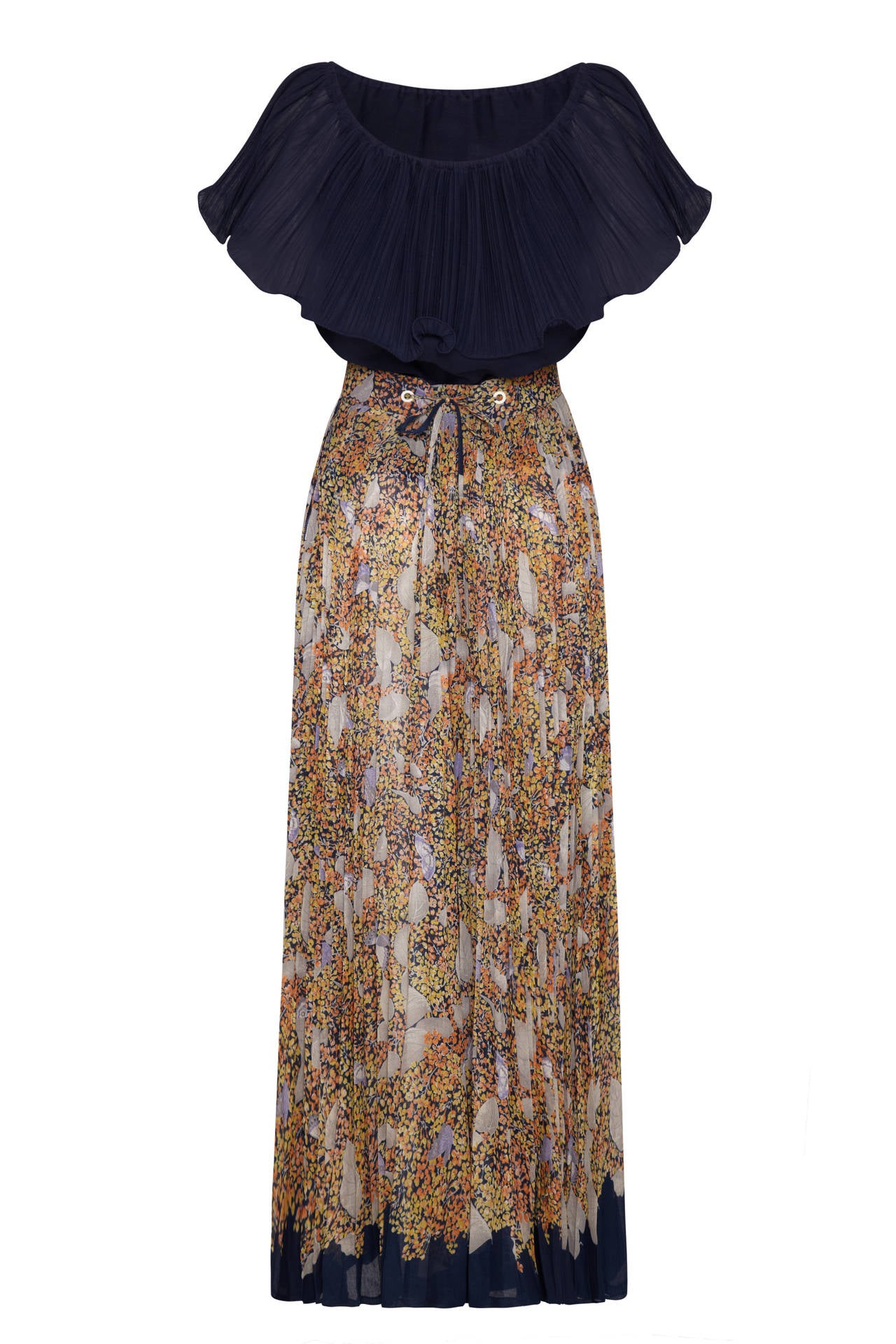 This 1970s pleated cotton outfit from American boutique brand Elissa of California is made up of two separates along with a matching floral fabric tie belt to draw in the waist. The ankle length skirt is tightly pleated with a delicate print in