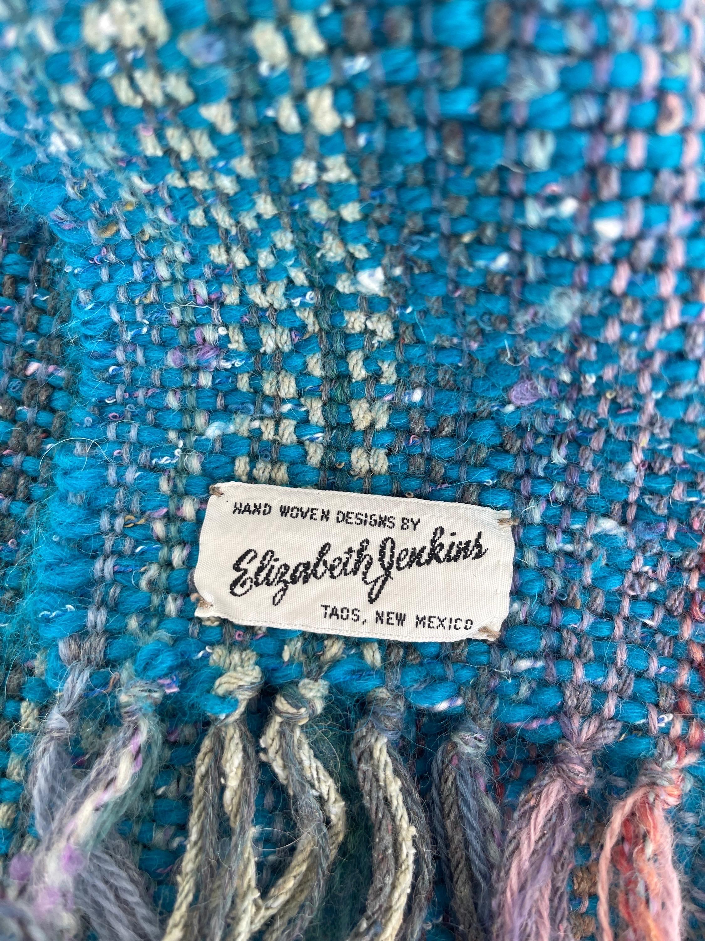 Beautiful late 70s ELIZABETH JENKINS XL mohair shawl ! This piece was loomed entirely by hand in colors of pink, turquoise blue, purple and white. The perfect weight for anytime of year. In great condition 
Made in Taos, New Mexico,