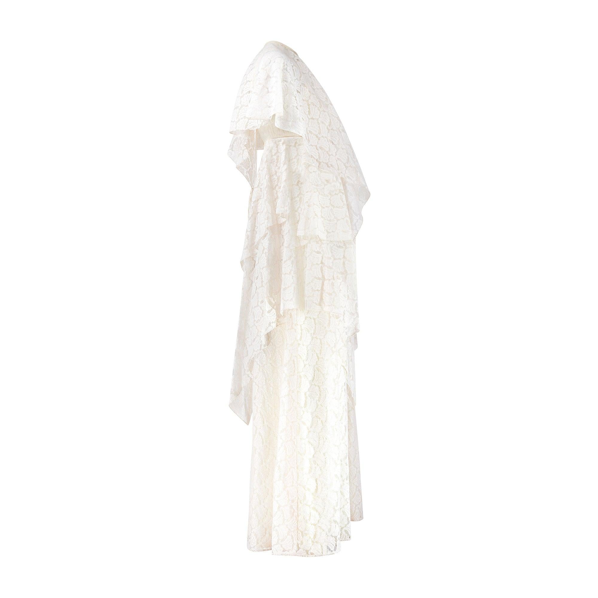 This enchanting wedding dress, with its tiered construction and layers of delicate, machined lace was created in the 1970s by well-known UK heritage bridal brand - Ellis.  The company, formed over 110 years ago, was pioneered by female founder Ada