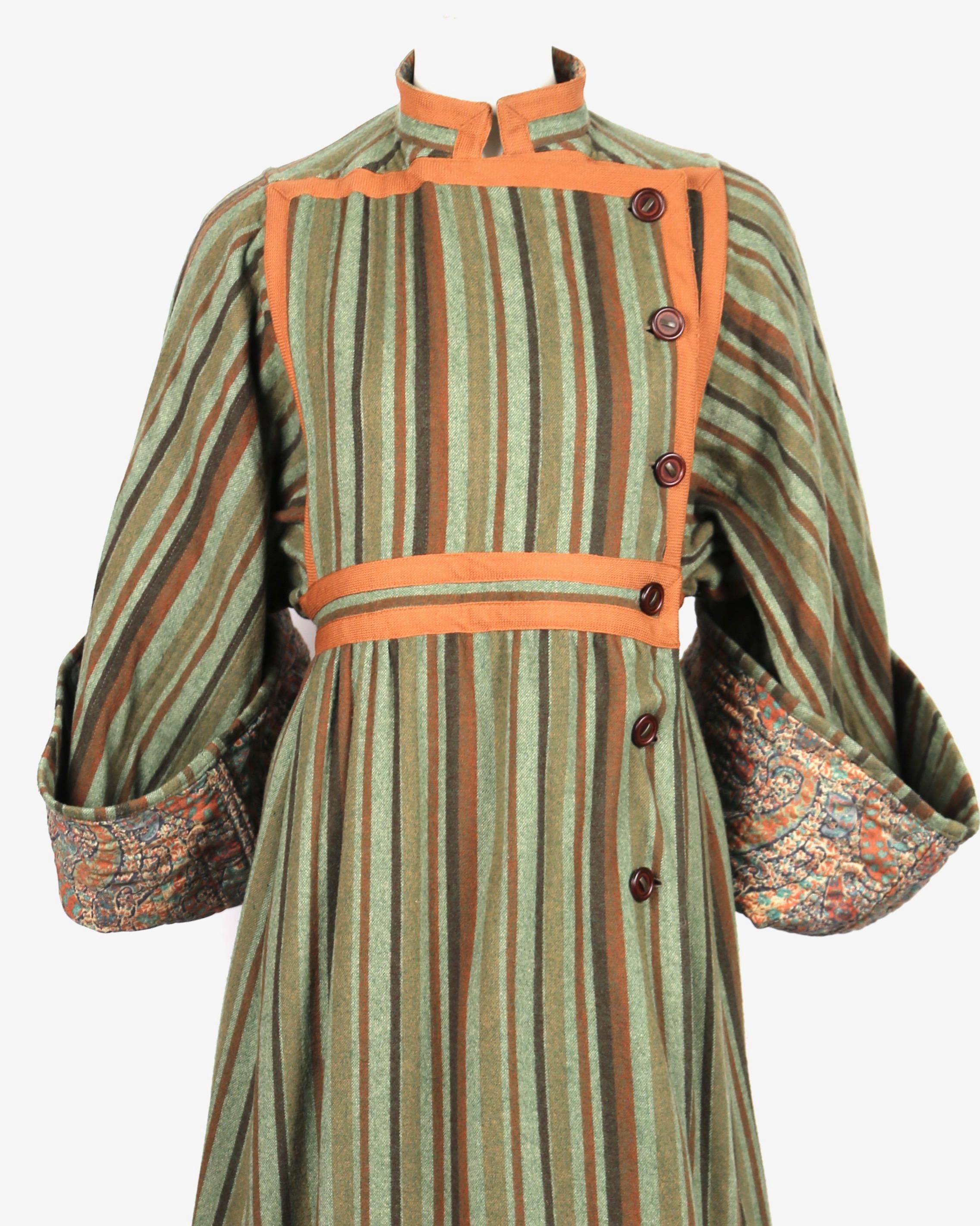 Green, brown and rust colored, striped, wool peasant coat with wide sleeves and paisley lining designed by Emaunel Ungaro Paraellele dating to the 1970's. Vintage size 10 which best fits a modern US 4-8. Approximate measurements: shoulder seam