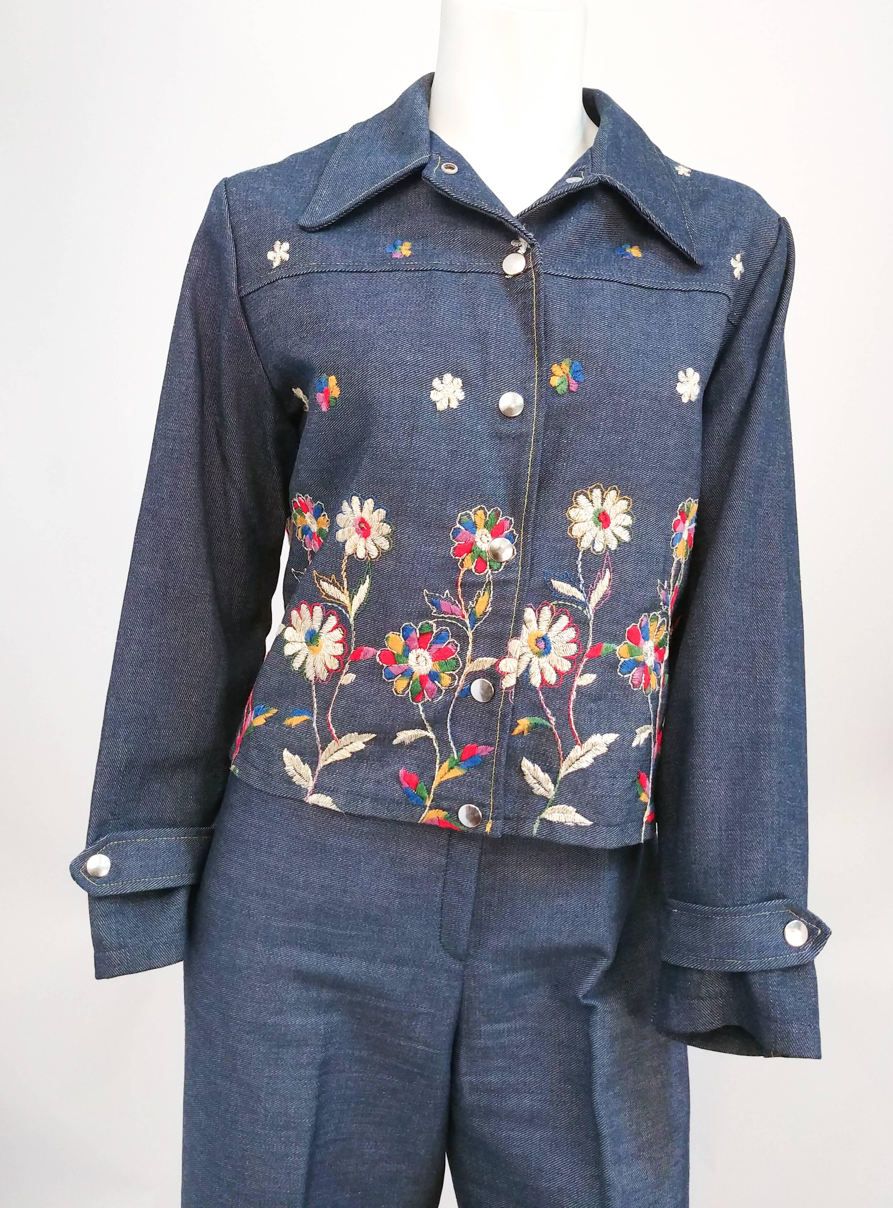 1970s Embroidered Demin Two Piece Set. Two piece denim set with embroidered flower border. Snap front buttons on jacket and pant. 