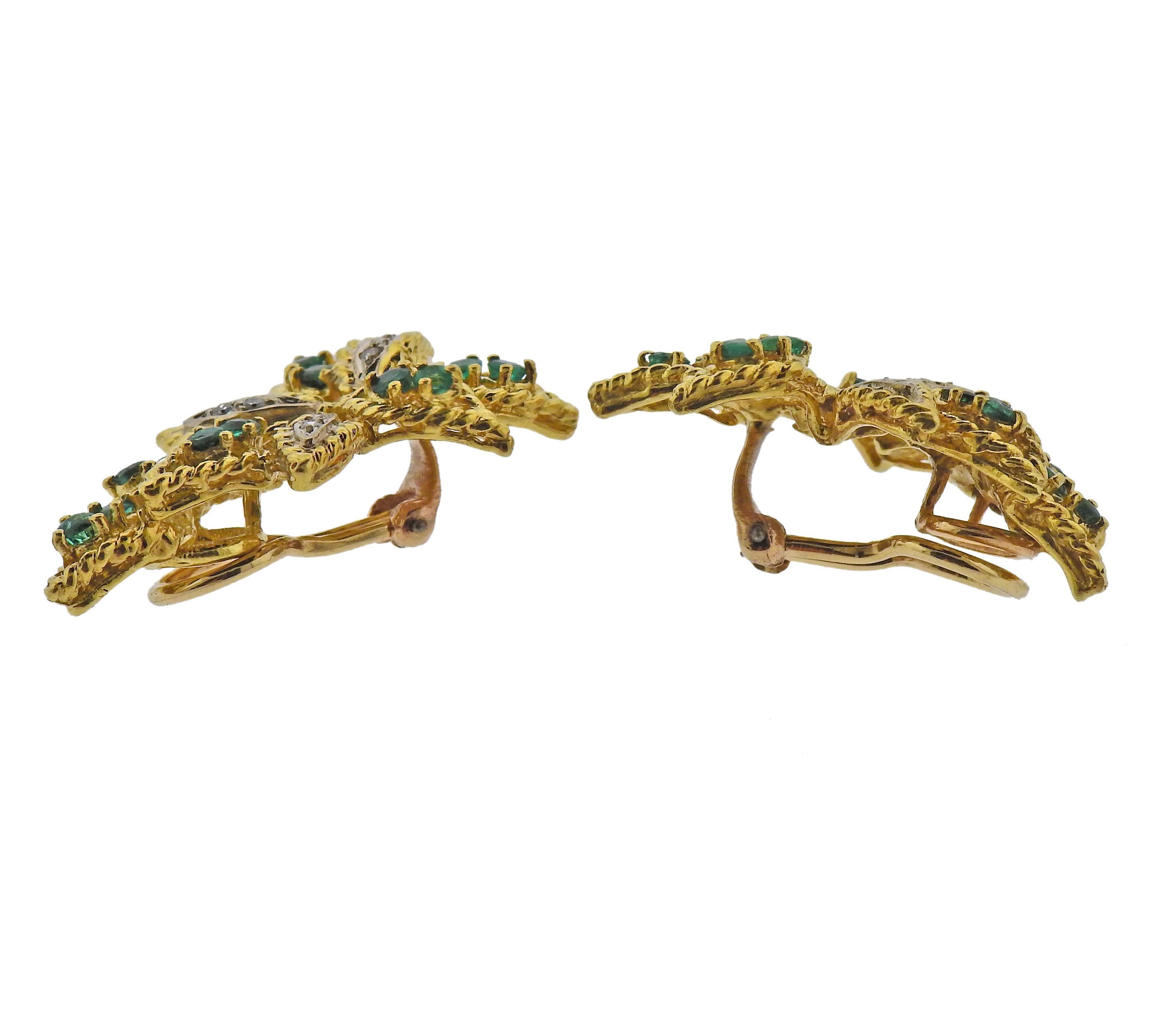 Pair of 18k gold earrings from circa 1970s, with 14k gold backs. Set with emeralds and approx. 0.12ctw in SI/H diamonds. Earrings measure 32mm x 20mm. Weight - 14.3 grams. Marked: 18k on earrings, and 14k on backs.