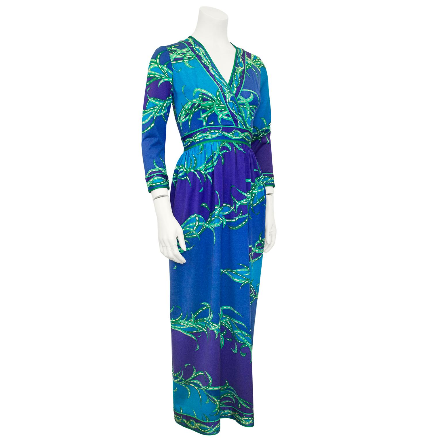 A classic and beautiful Emilio Pucci maxi dress dating from the 1970s. Blue and purple abstract colour blocking with a green and white leaf style print throughout. A very flattering shape with a deep v neckline, bracelet length sleeves, a waistband