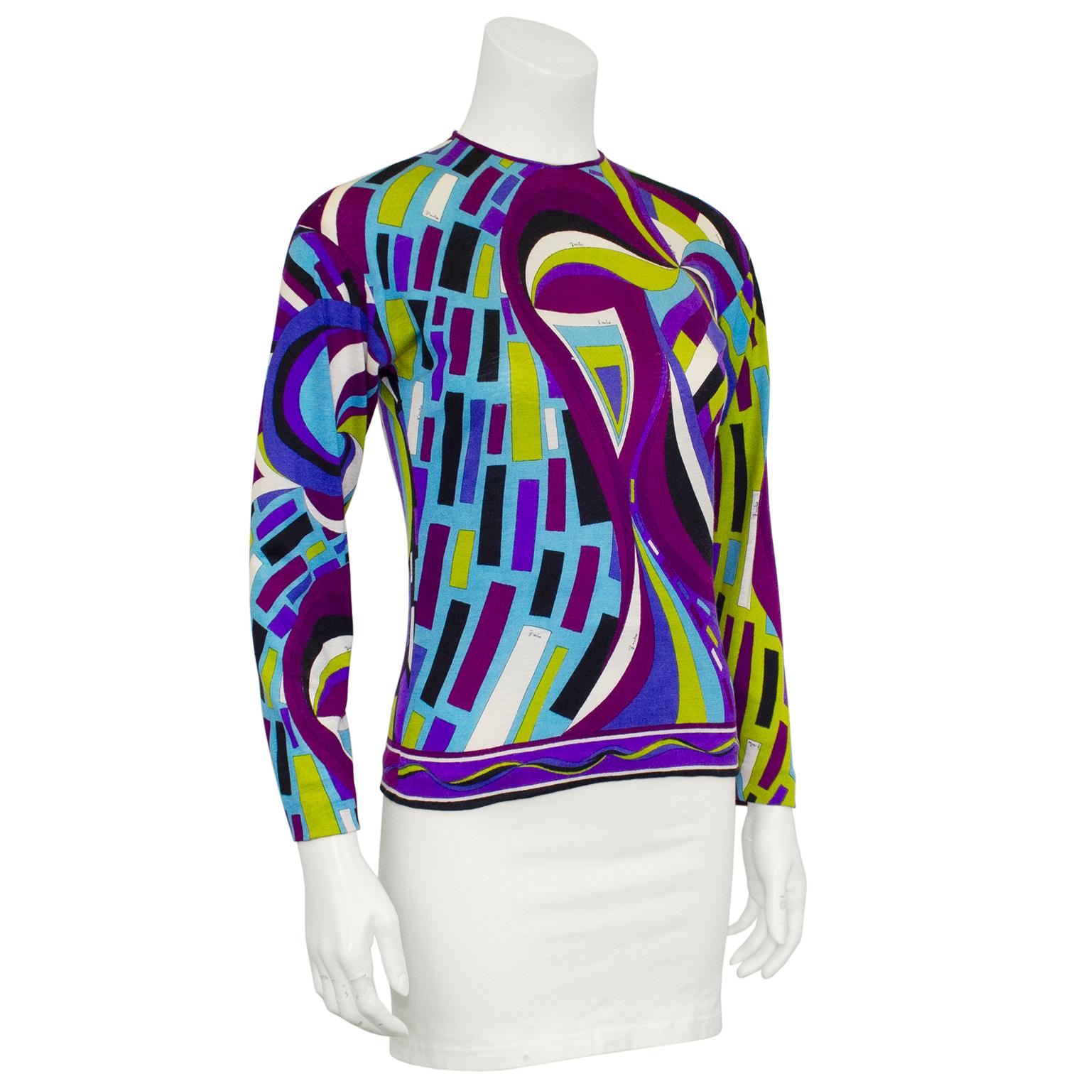 Beautiful Emilio Pucci very light weight pull over sweater from the 1970s. Made from a 90% cashmere, 10% silk blend, this sweater features the iconic Emilio Pucci brand abstract print in tones of dark purple, blue and lime green. Crew neckline and