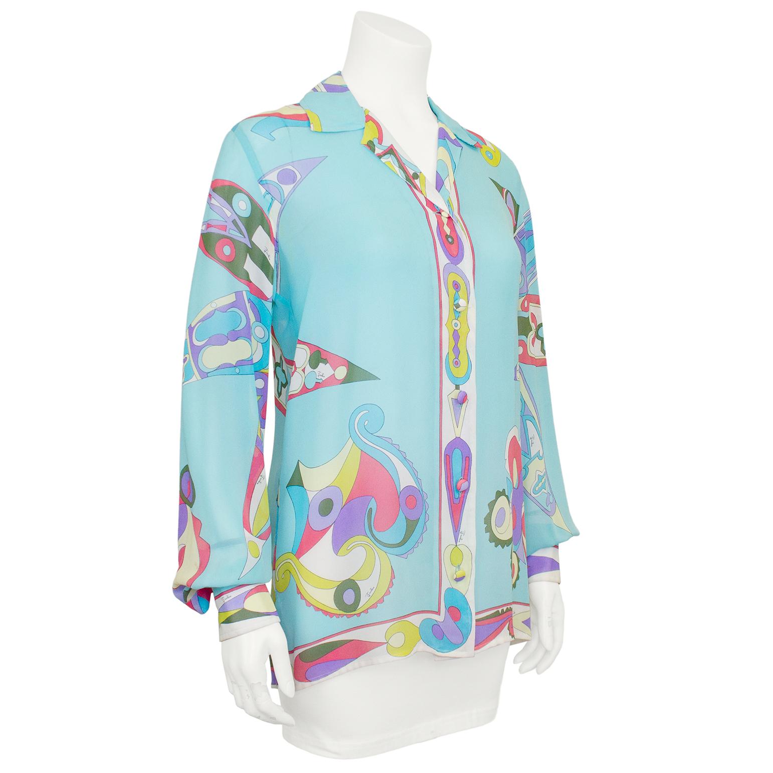 Gorgeous Emilio Pucci silk chiffon button down shirt from the 1960s. The turquoise background features a pink, purple, lime and green print on the front placket, hemline, sleeves and on the back in the shape of a star. Unlined and sheer. Fabric