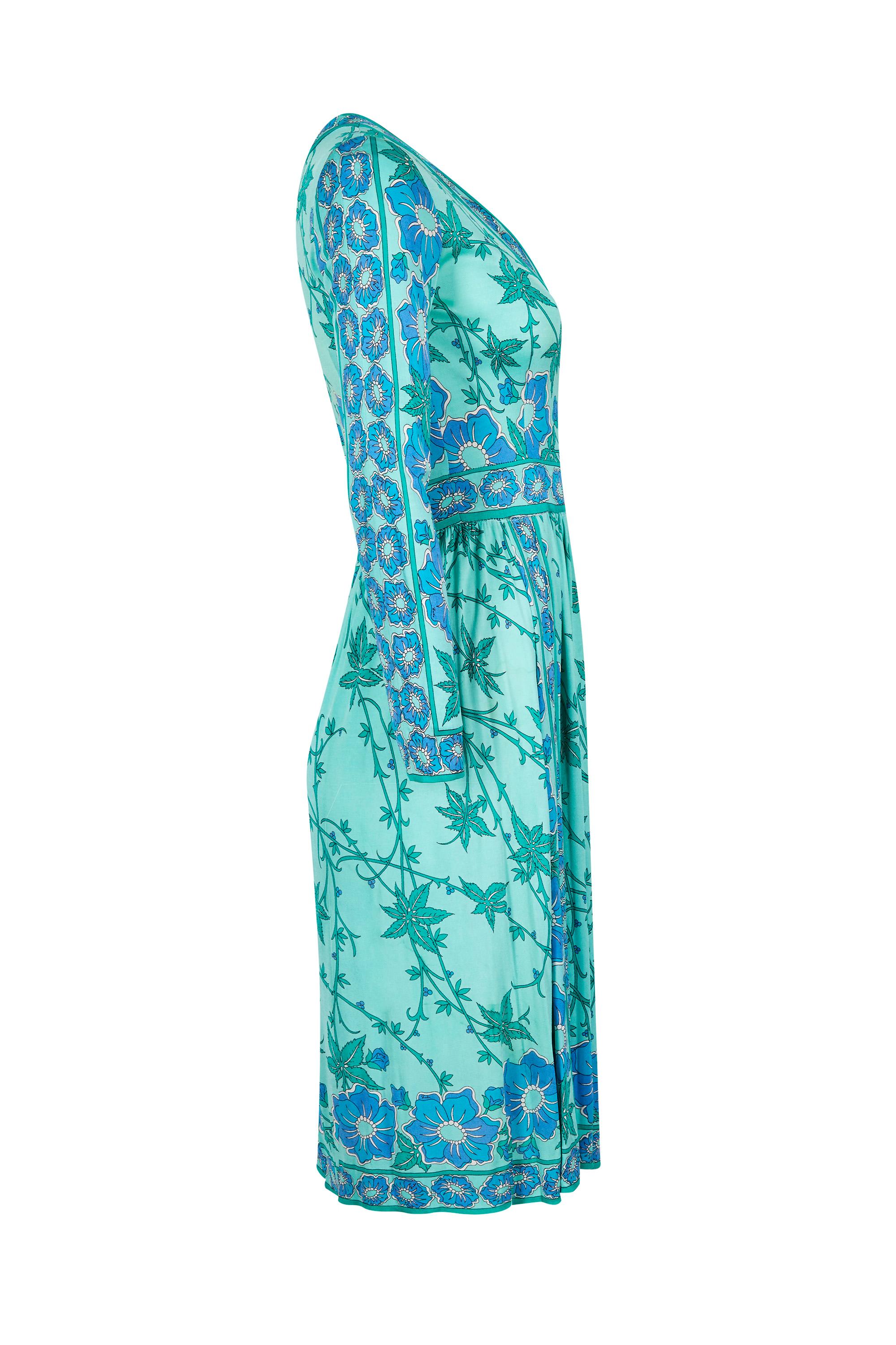 This beautiful 1970s turquoise printed silk jersey dress with an attractive cross over bodice is a classic piece by Emilio Pucci, retailed at Saks Fifth avenue and is in lovely vintage condition.  The soft silk jersey fabric has retained all of its