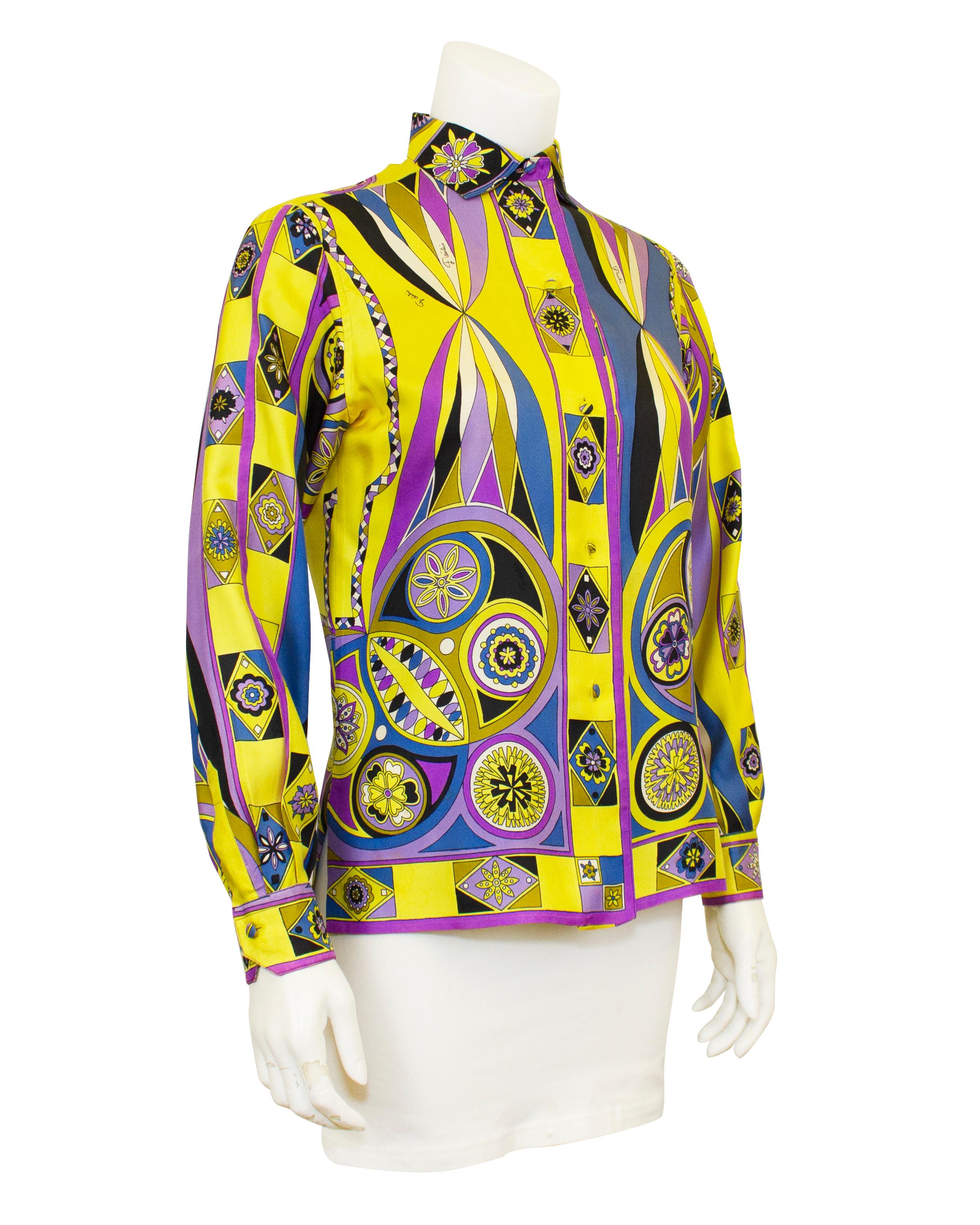 Vibrant printed Emilio Pucci silk shirt from the 1970s. Iconic Pucci abstract geometric and floral print in bright yellow, purple, blue and black. The upper back features a large butterfly. Fabric covered buttons and signed fabric. Classic Italian