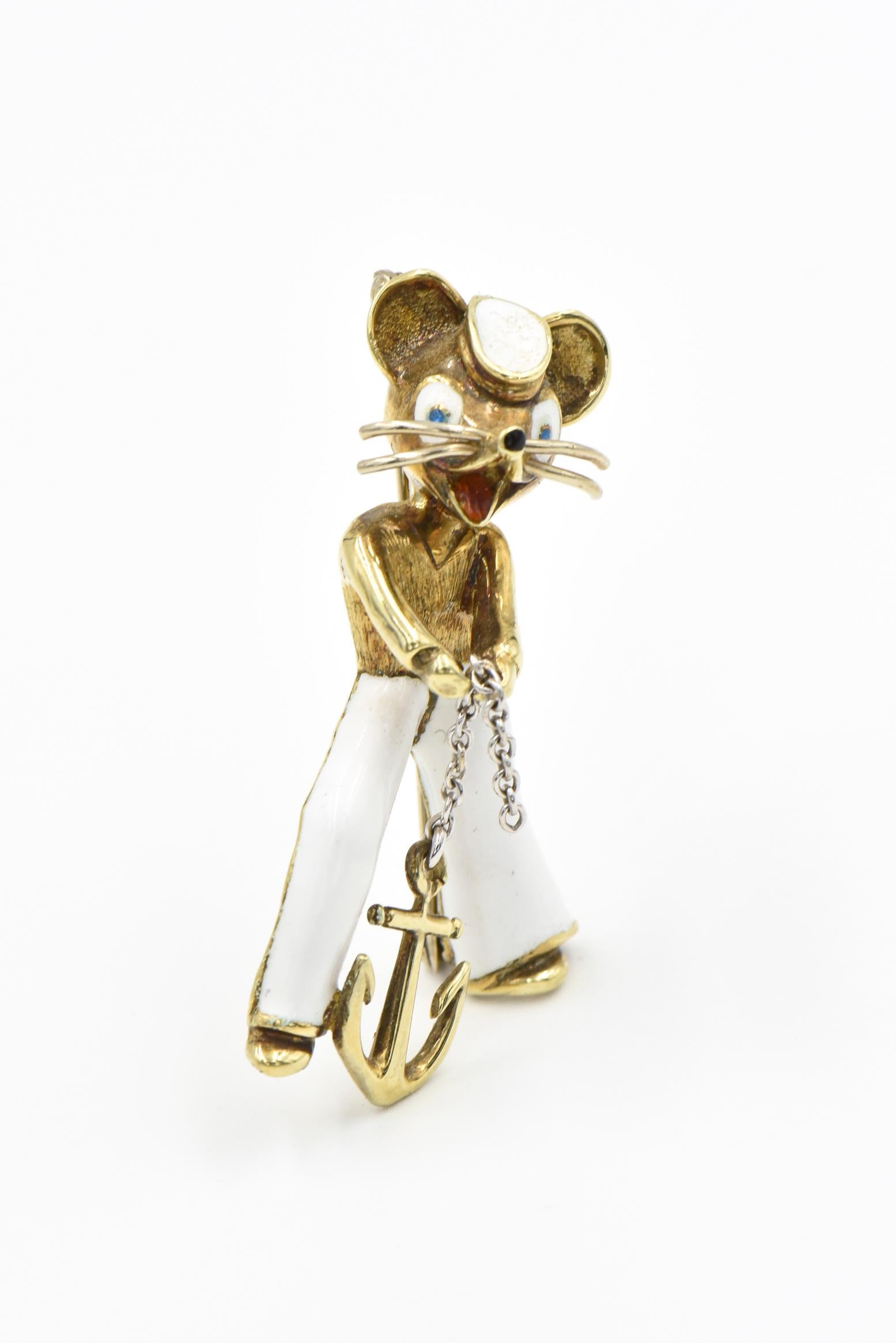 This fantastic mouse was produced by Martine in Italy in late 20th century.  The enamel mouse sailor is wearing white pants with a matching white cap.  He is holding a loose chain which is attached to a gold anchor.  His eyes, nose and mouth are
