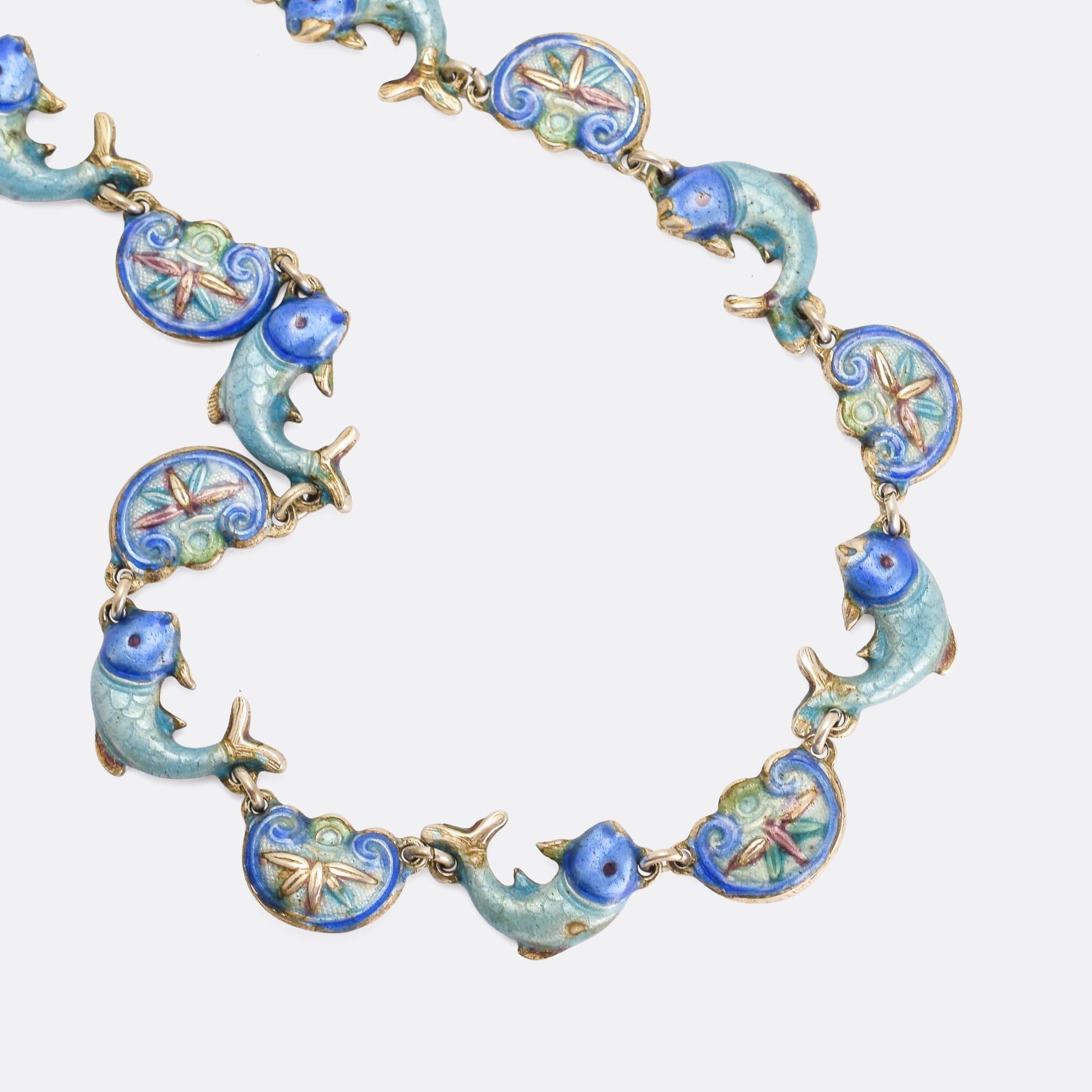 A cute vintage necklace featuring colourfully enamelled fish and lotus motifs. It’s Chinese, made in the 1970s, and modelled in silver throughout.

MEASUREMENTS
Wearable length: 16 inches

WEIGHT
23.5g

MARKS
No marks present, tests as Silver
