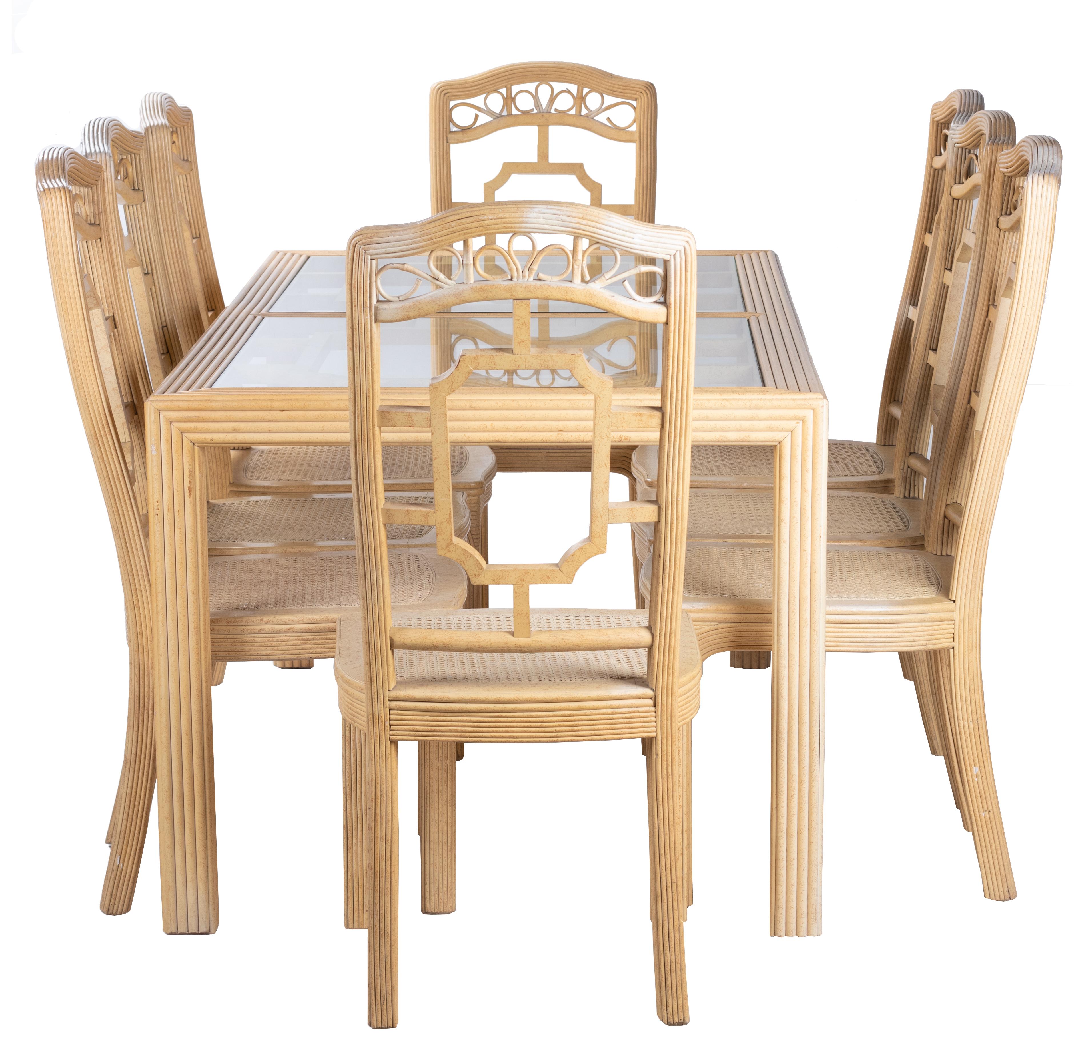 1970s oriental style bamboo dining set composed of eight chairs and table, bought in Harrod's, London.      
  