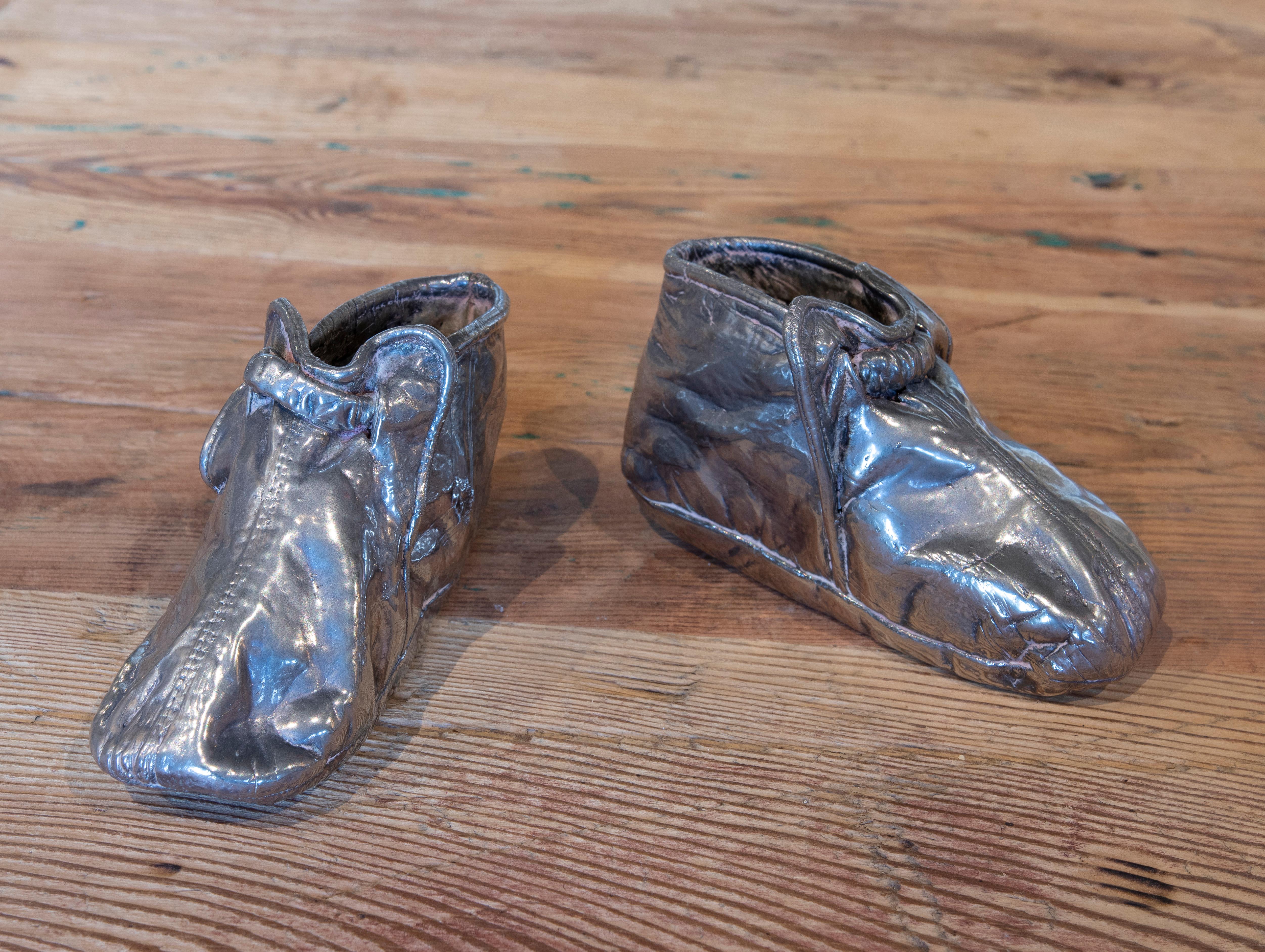 1970s English pair of silver plated metal shoes.