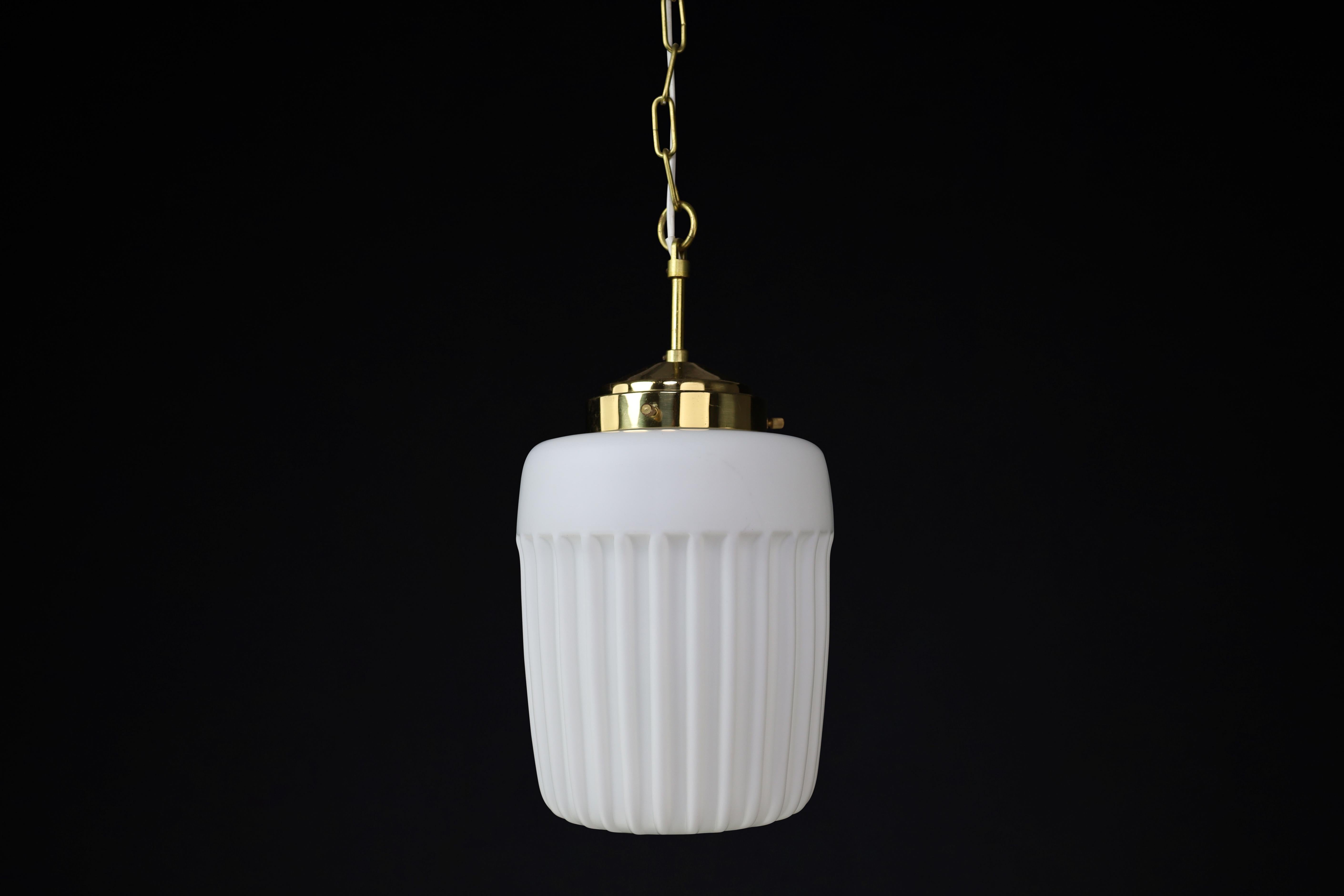 1970s European Mid-Century Modern Opaline Glass & Brass Pendant Lights – Set of Six Available

A beautiful blend of simplicity and elegance, these 1970s Mid-Century Modern pendant lights bring a refined touch to any interior. Originating from