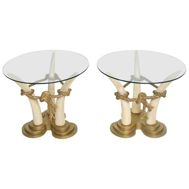 1970s by designer Italo Valenti of Spain VALENTI & CO 
Exotic side tables faux ivory bases made from painted hardwood.
Each faux tusk is connected by bronze rope and topped by a round glass panel that allows full view of the elaborate base.
The faux