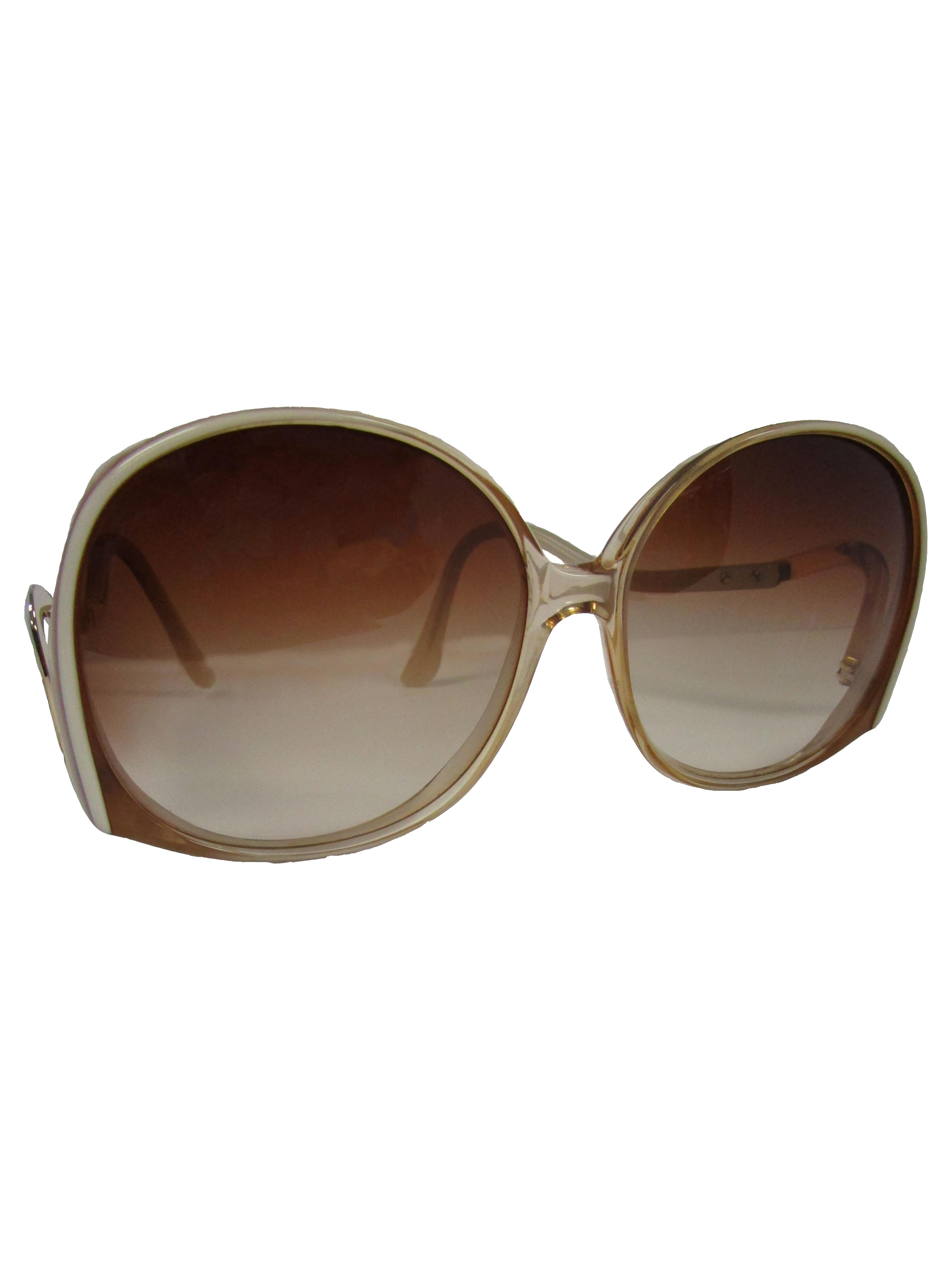 
Beautiful sunglasses from Pierre Cardin. They feature an ombre tint and an amber resin inlay on the arms that brandish the Cardin logo. The color palette on these sunglasses make it easier to wear all year round, in style!

Width: 5.5 inches
Arm