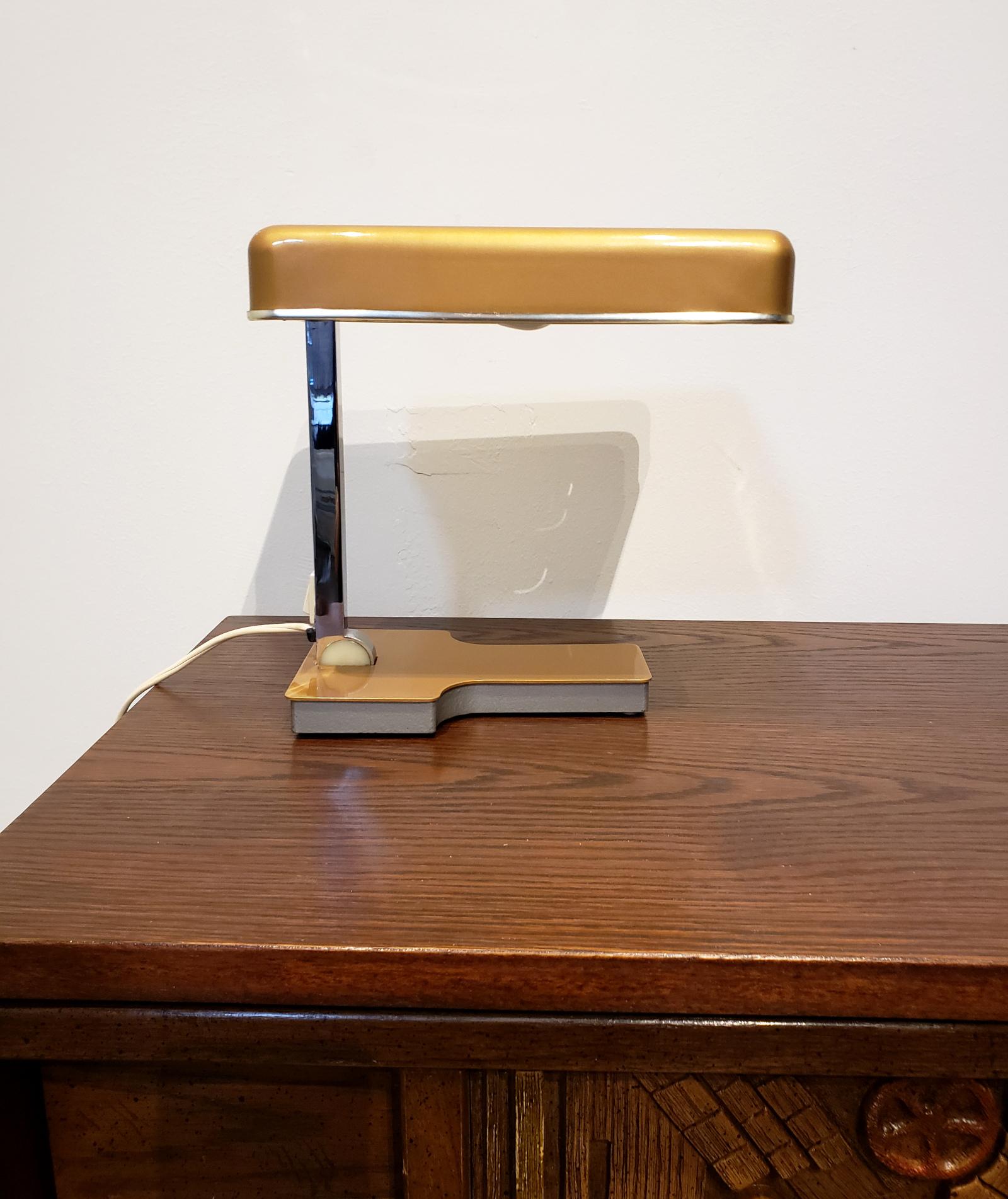 Fase mini desk lamp, designed and manufactured by Fase Madrid in the 1970s. Folds almost completely flat for easy storage or take it on the go! Top can be adjusted up and down or forward and back. Steel top finished in a tasteful gold with chrome