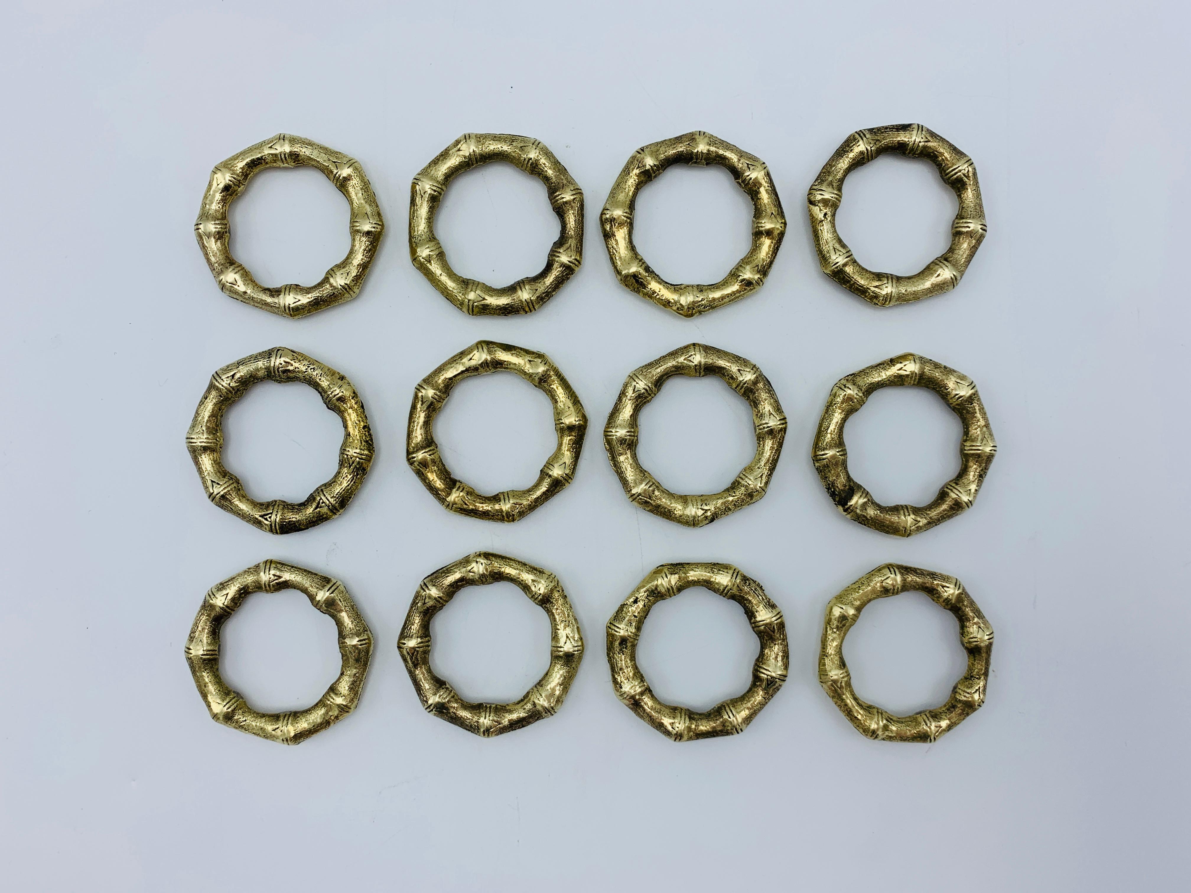 Listed is a fabulous, set of 12, thick brass faux bamboo napkin rings, circa 1970s. Each ring measures 1.88in diameter x 0.25in height. The whole set is heavy, weighing 1lb.