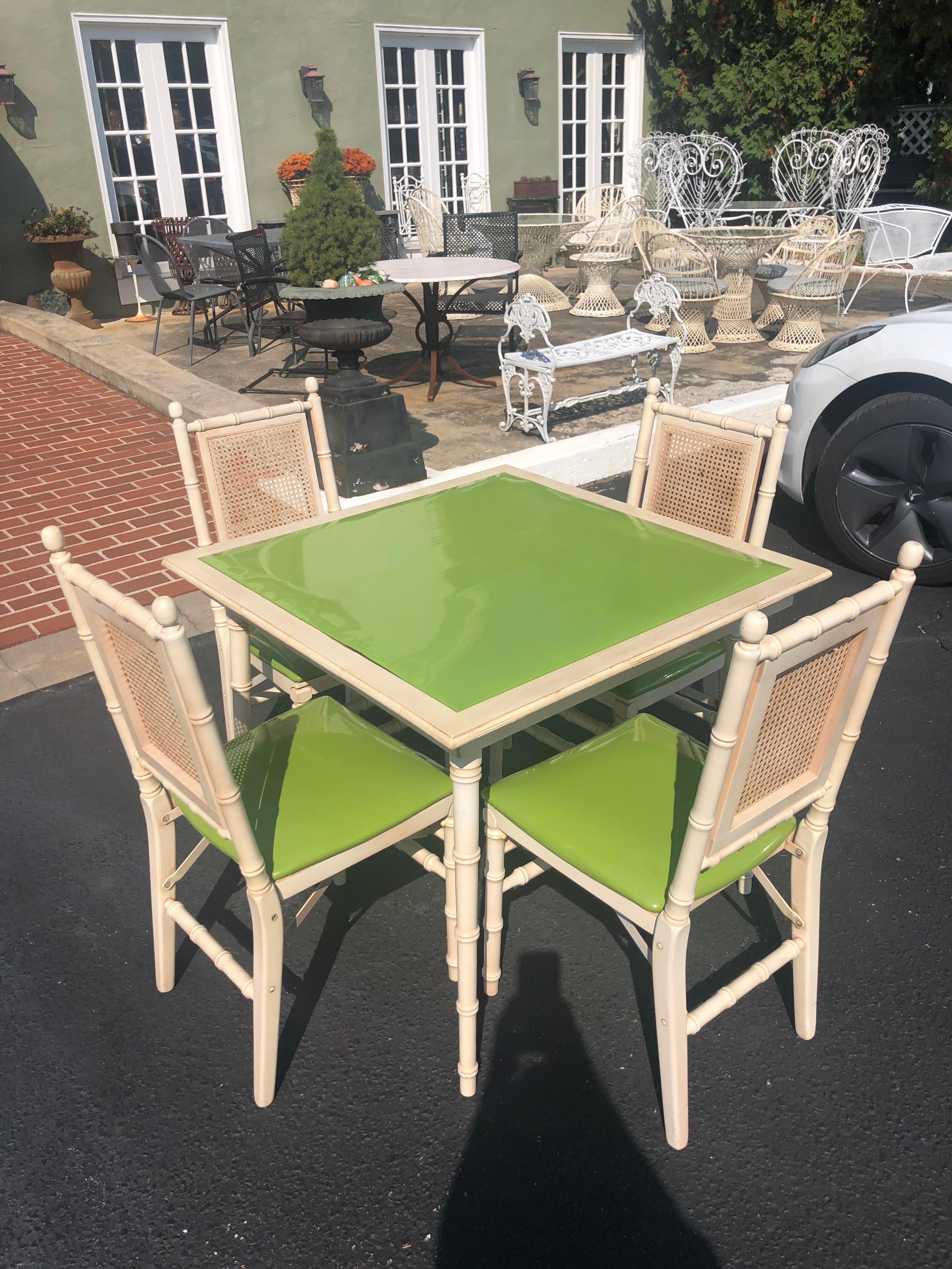 1970s faux bamboo square game table with four chairs. All are collapsible and able to store away.
Fabulous kitchy retro apple green vinyl fabric top to table and chairs. Please request dimensions.

Seat Height: 18 inches
Seat With: 16.5 inches
Seat