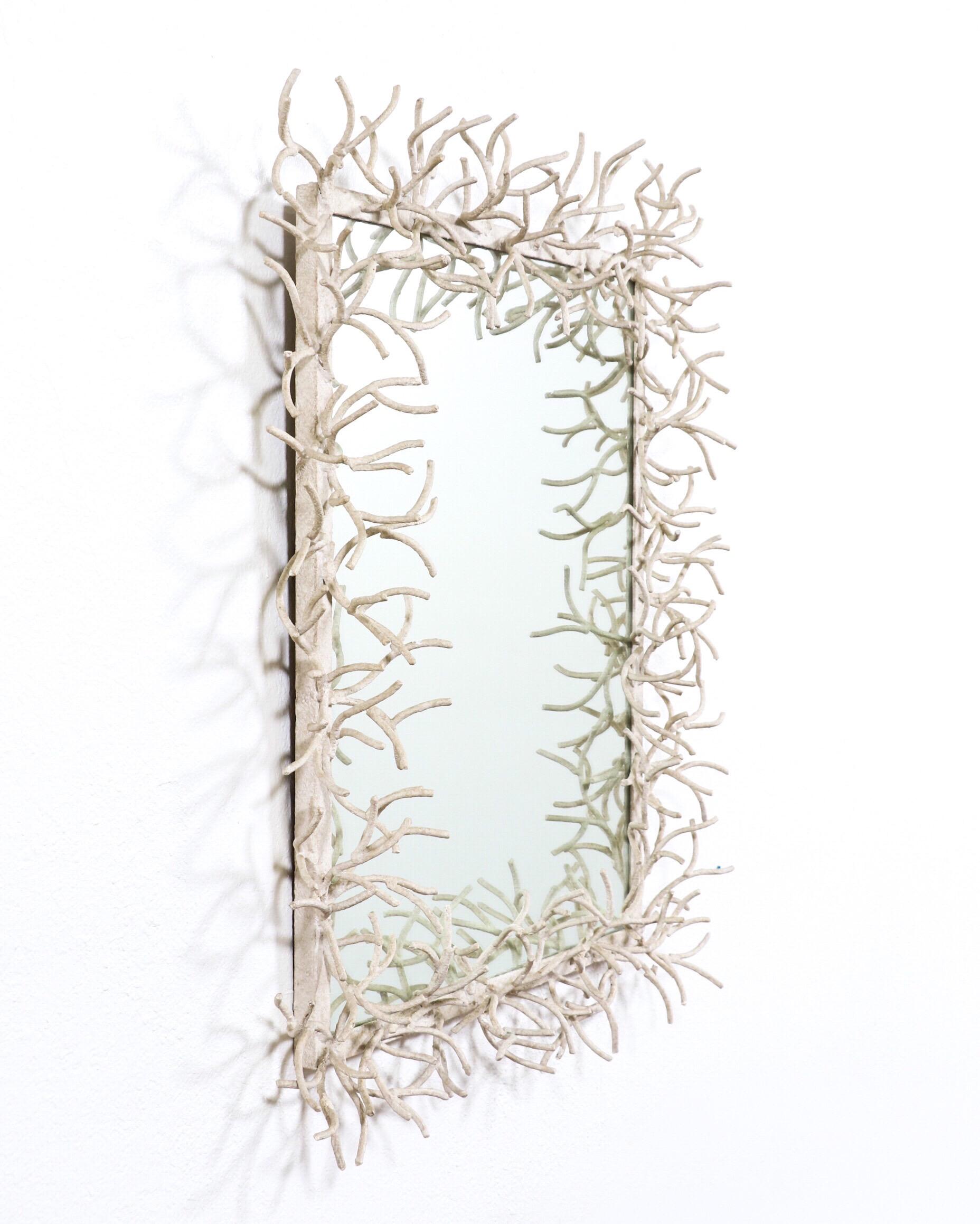 Fabulous, 1970s painted faux-coral wrought iron frame with a glass mirror insert.

The mirror has an organic and modern aesthetic that would fit perfectly in midcentury to contemporary settings. 

 