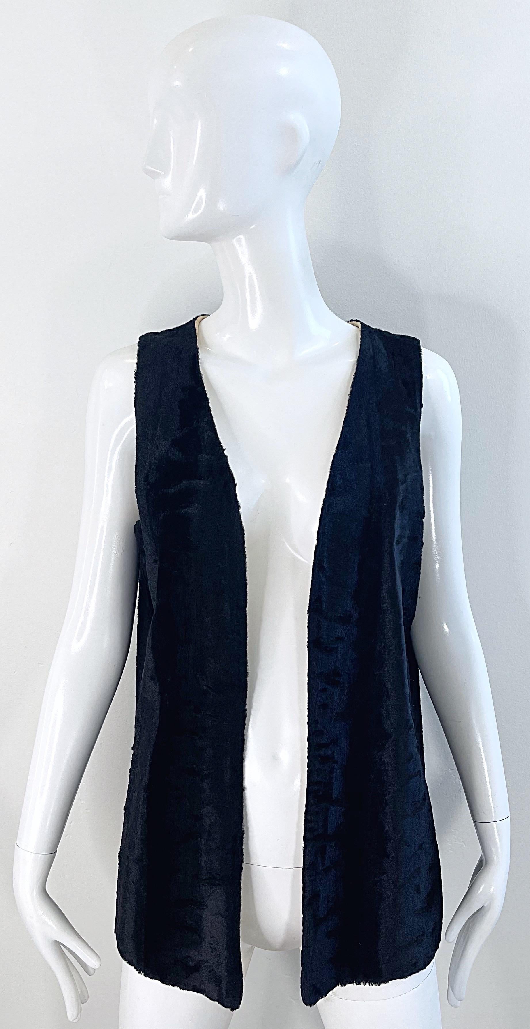 Stylish vintage 70s faux fur black vest ! Features lightweight super soft faux fur that could easily be worn anytime of year. Lined in an ivory silk. Great with a belt or layered over your favorite shirt. 
In great condition 
Made in