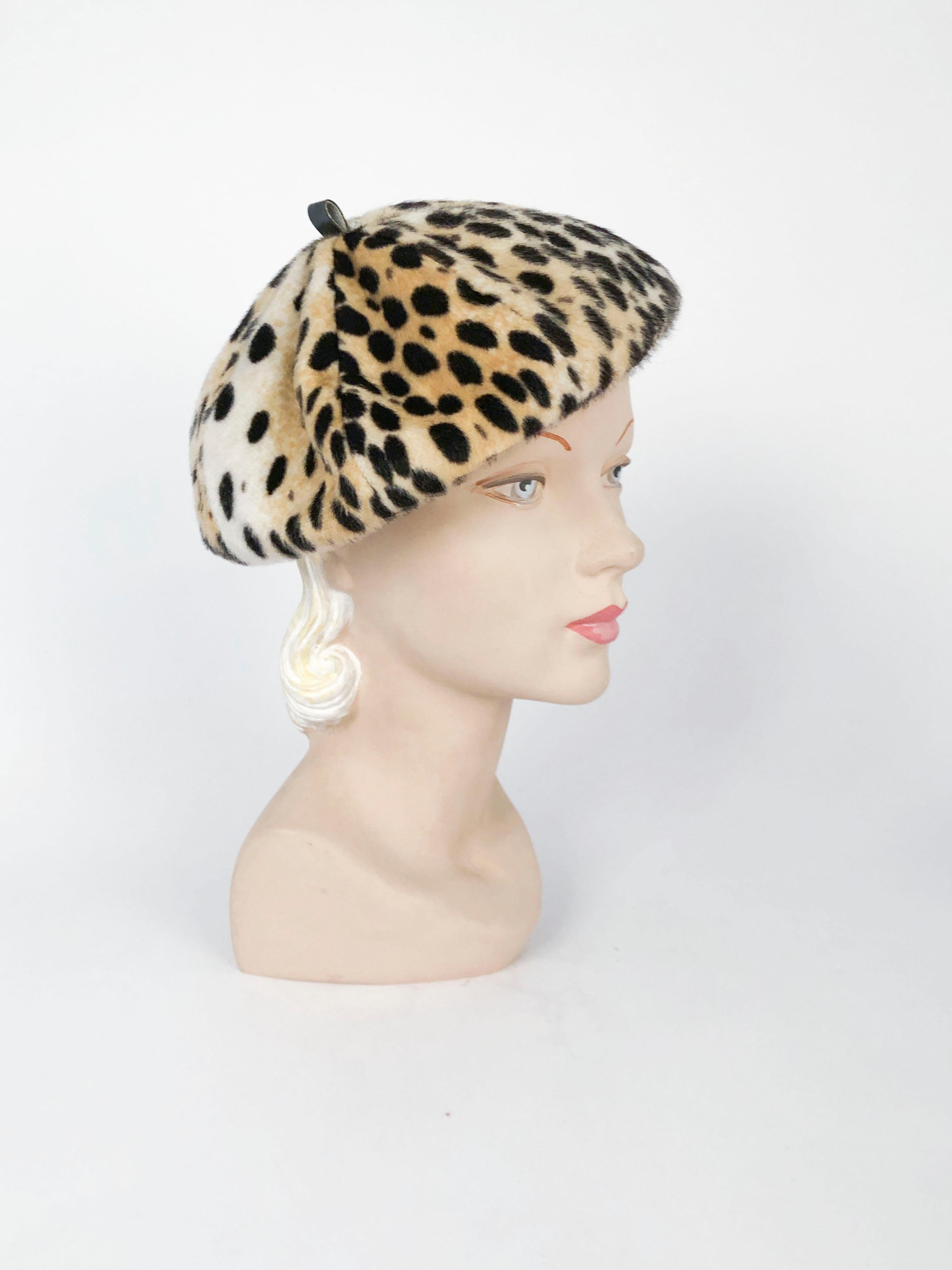 1970s Faux Fur Cheetah Print and Vegan Leather Beret. The inner band is made of vegan leather and matches the fabric on the hat stem finishing the 8-panel construction