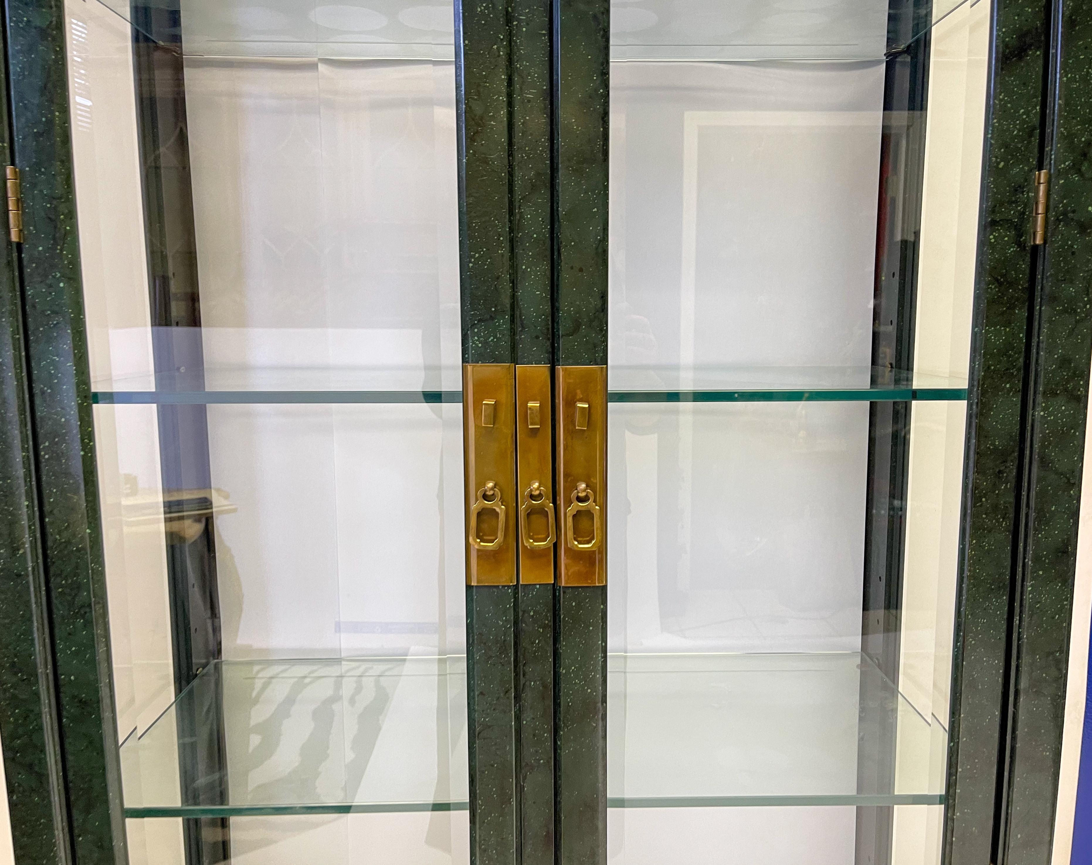 This is a wonderful pair of mirrored Asian style cabinets by Henredon. The green faux malachite finish is original. The backs are mirrored and shelves are adjustable. The pieces are electrified. They are in very good condition.