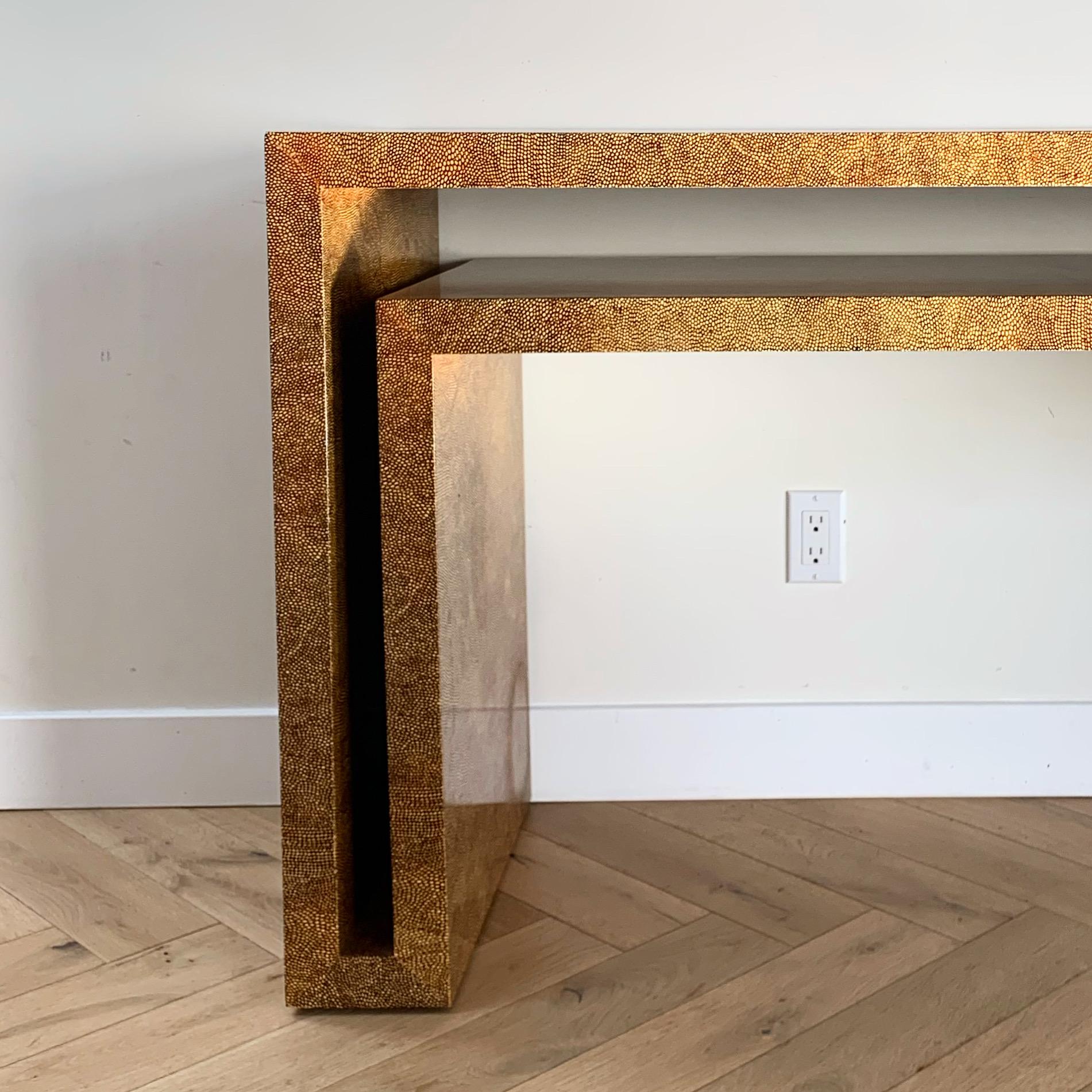 Faux shagreen geometric “cut out” console table circa early 1970s. Solid wood construction ie heavy. Finishing is vaguely reminiscent of leopard print. Could also function as a desk. Some edge wear (shown in pics in close up) but overall good