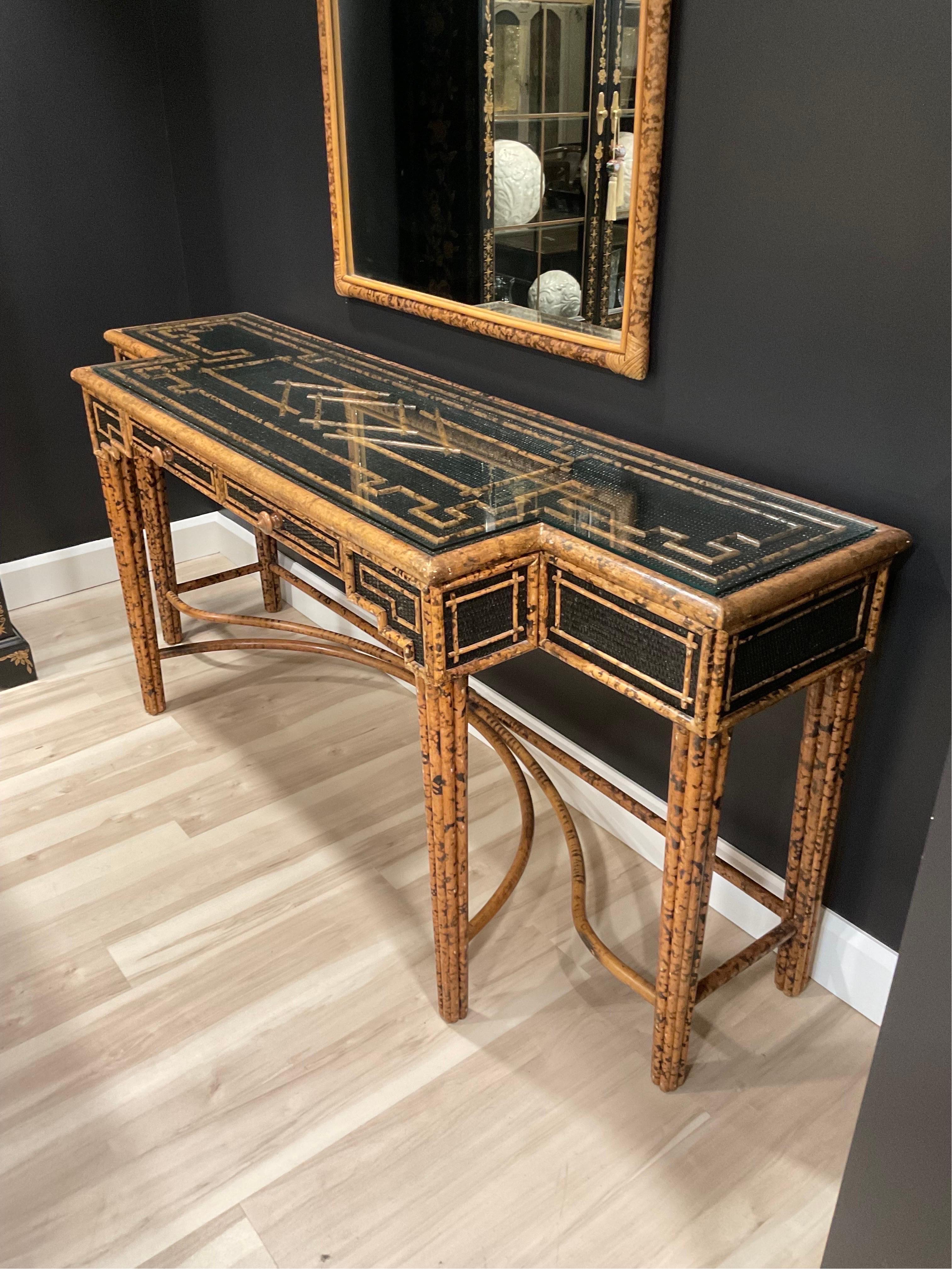 Rare Faux Tortoiseshell painted Ratan and Bamboo Console Table with matching mirrors and custom glass top. Intricate details abound and finished on all four sides. Beautiful pieces.


Condition Disclosure:
Please understand nearly all of our